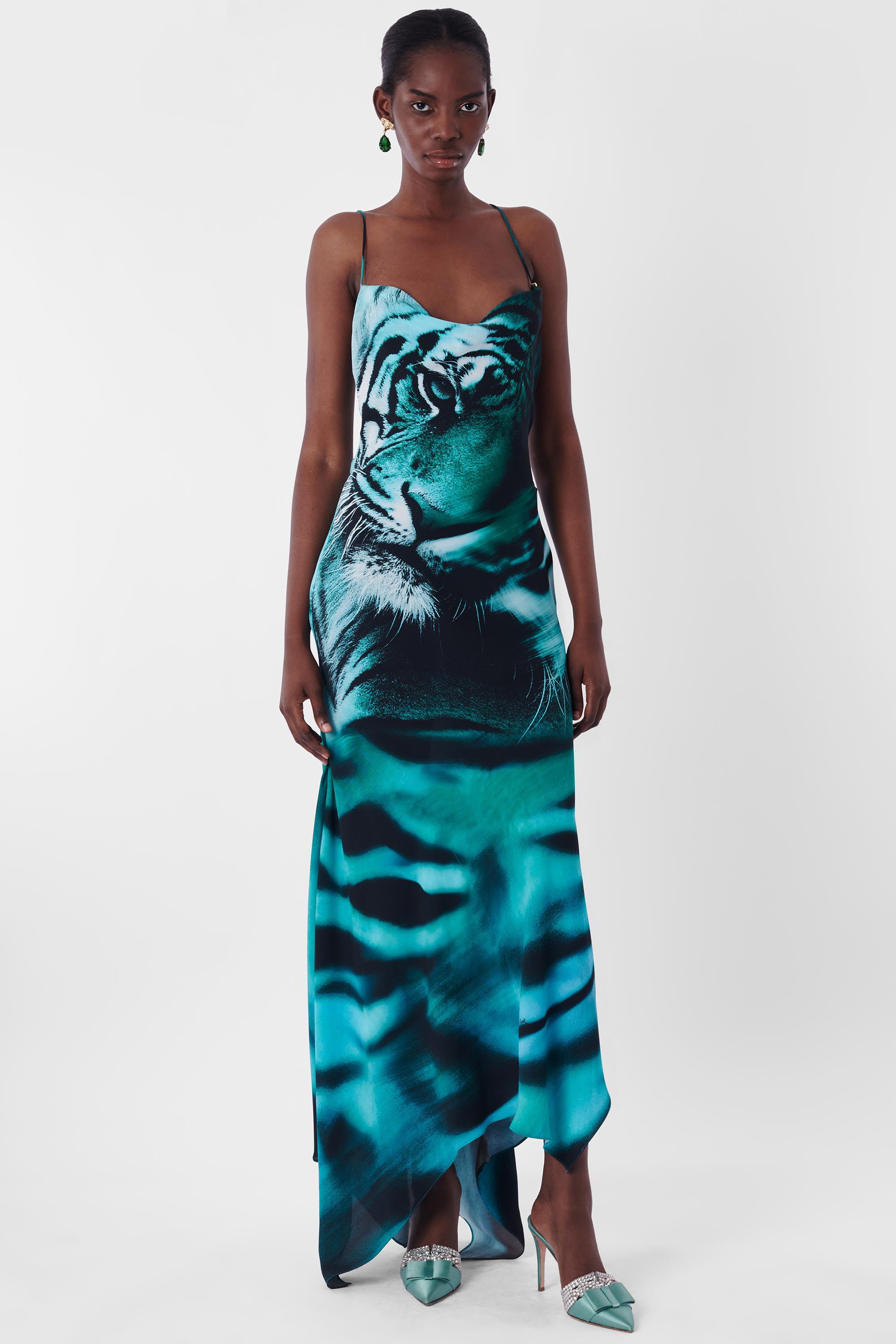 Roberto Cavalli S/S 2022 Blue Tiger Dress. Features cowl neck, open back with concealed zipper, gold tiger teeth on straps, asymmetric hem. In excellent vintage condition. As seen on Dua Lipa.

Brand: Roberto Cavalli
Size: UK 8
Color: Blue
Label