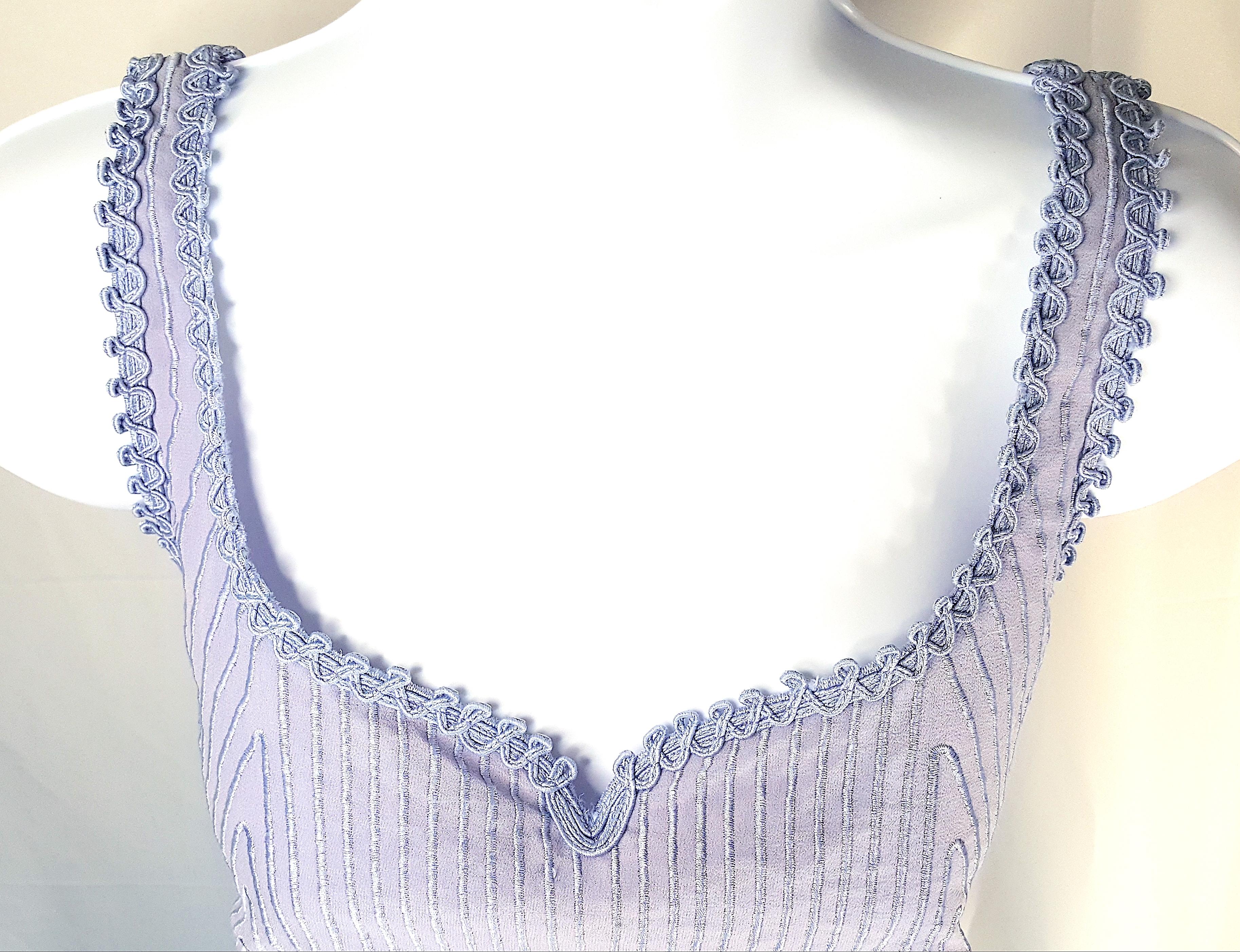 The late Italian fashion designer Gianni Versace near the end of his life--cut short by his murder in July 1997--designed this couture heavily-embroidered semi-transparent silk chiffon sleeveless hourglass corset-like side-zip pastel bodice for