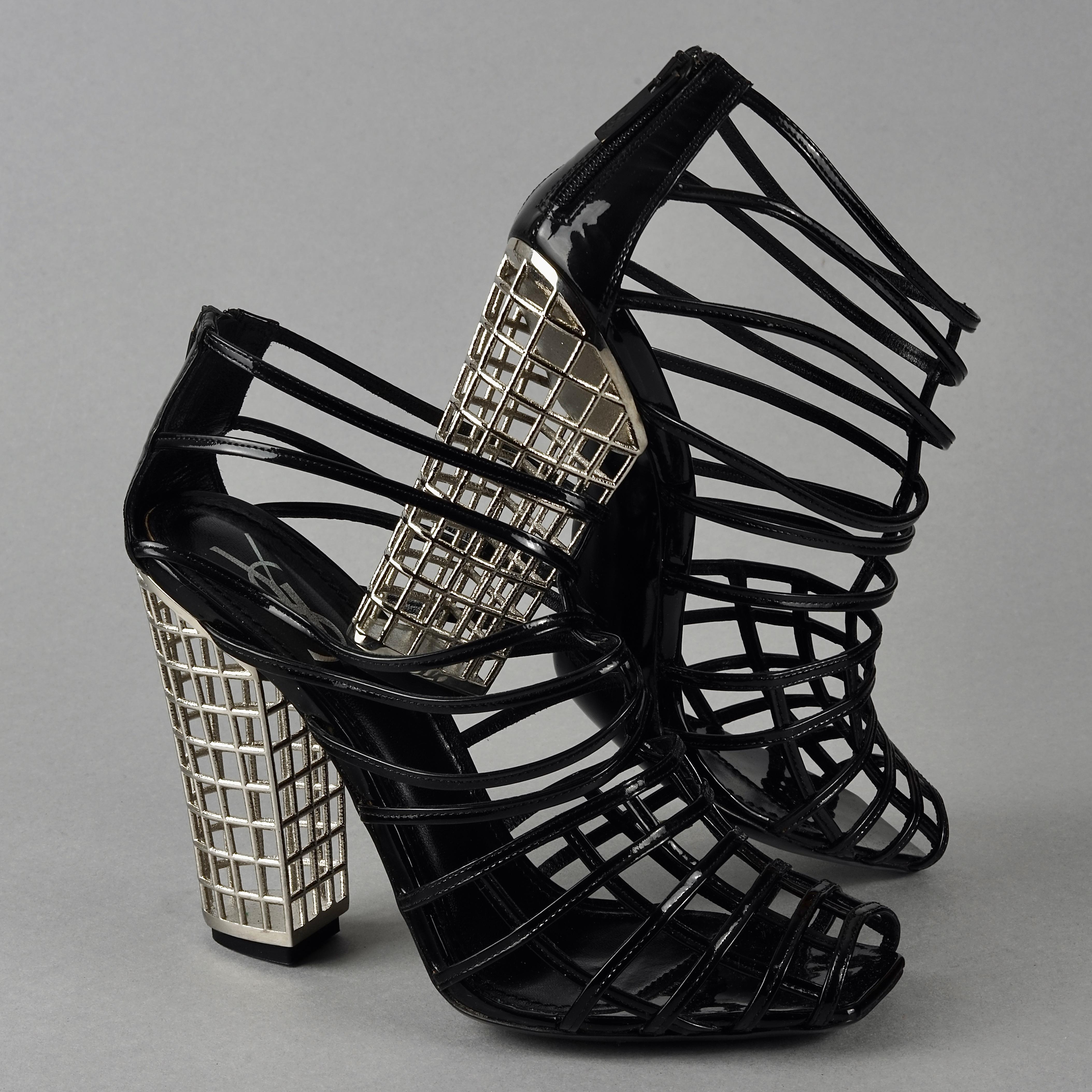 S/S2009 YVES SAINT LAURENT Ysl Cage Heel Ankle Boots

pointure 38 cm hauteur talon 11,5 cm
Measurements:
Size: 38 EU
Heel: 4.5 inches (11.5 cm)

Features:
- 100% Authentic YVES SAINT LAURENT.
- Black patent strappy ankle boots with metal cage heels