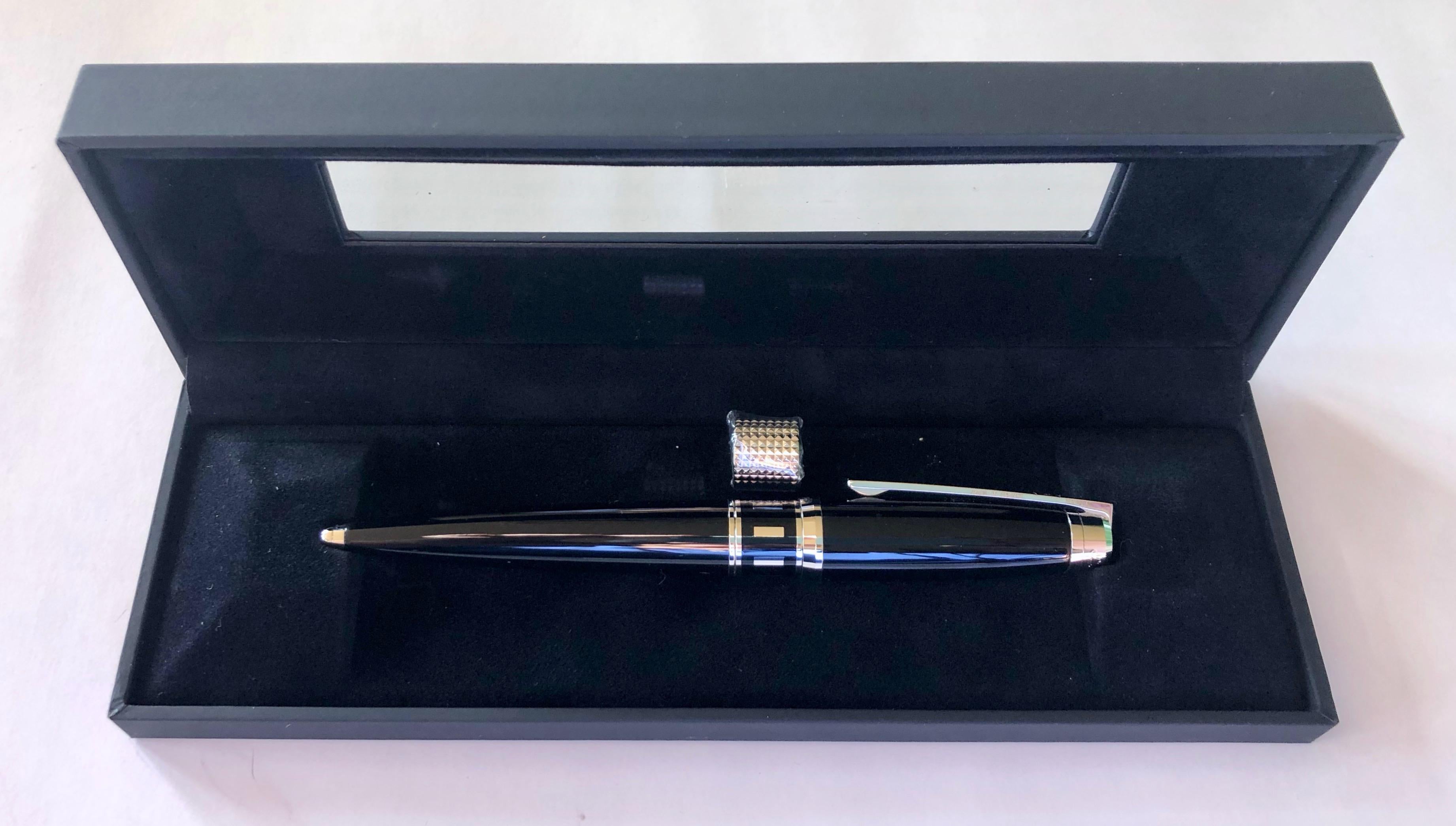 This French S. T. Dupont Paris Caprice Ballpoint Pen is in black lacquer and palladium with diamond head rings. It is brand new in it's original case with all papers and a worldwide 2 year warranty card.