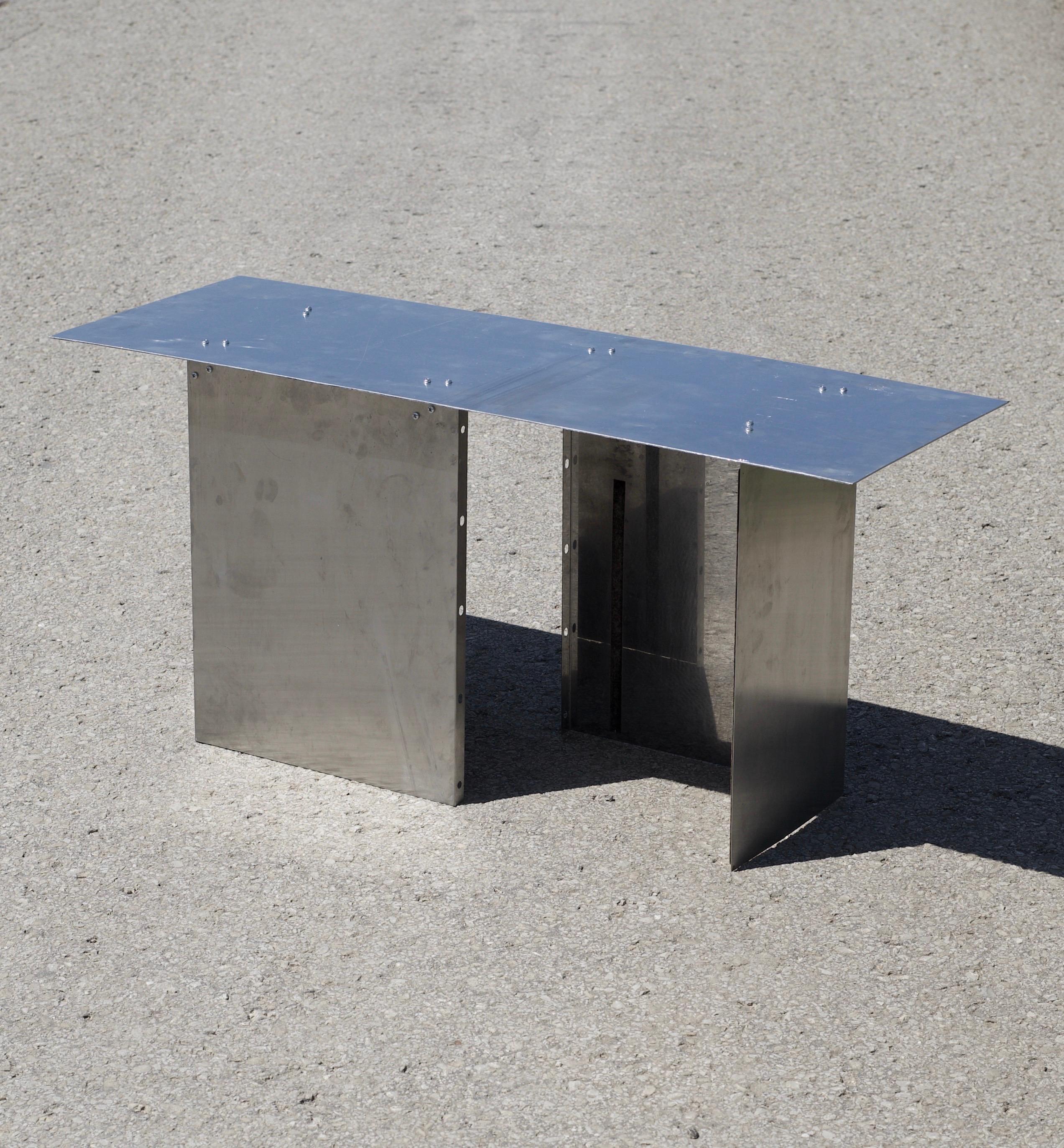 ‘S0-2H’ lounge table by Maximilian Hofmann
Dimensions: D 40, W 100, H 45 cm
Materials: aluminium.
Finish: rolled and polished aluminium.
Weight: 9.8 kg. 
Material thickness: 0.4 cm

‘S0-2H’ lounge table from the Undigested collection by