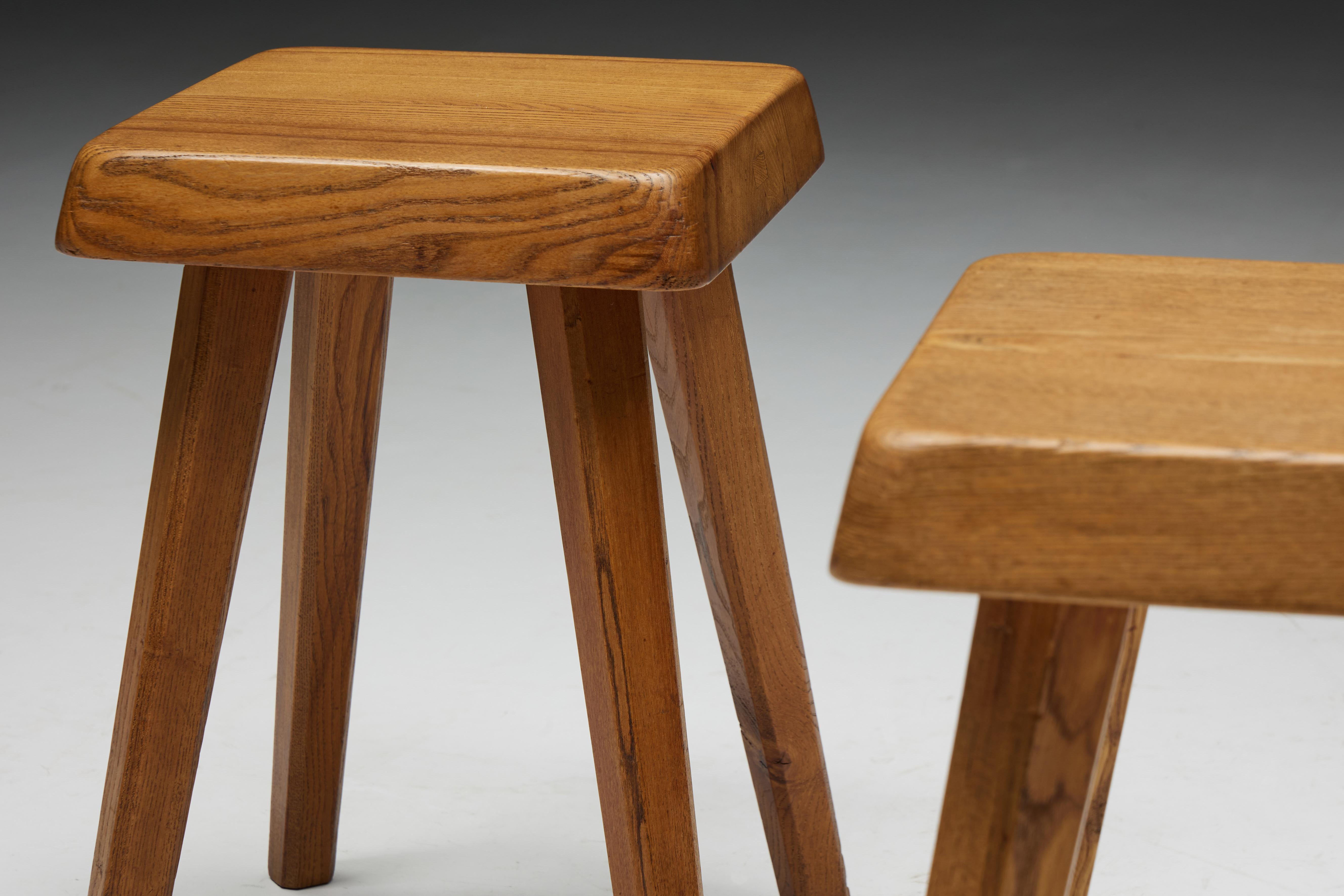 S01 stools by Pierre Chapo in solid elm wood. These stools are crafted with precision in 1970s France. Crafted with precision and care, these stools exemplify Chapo's renowned craftsmanship and minimalist aesthetic. Each stool features a square seat