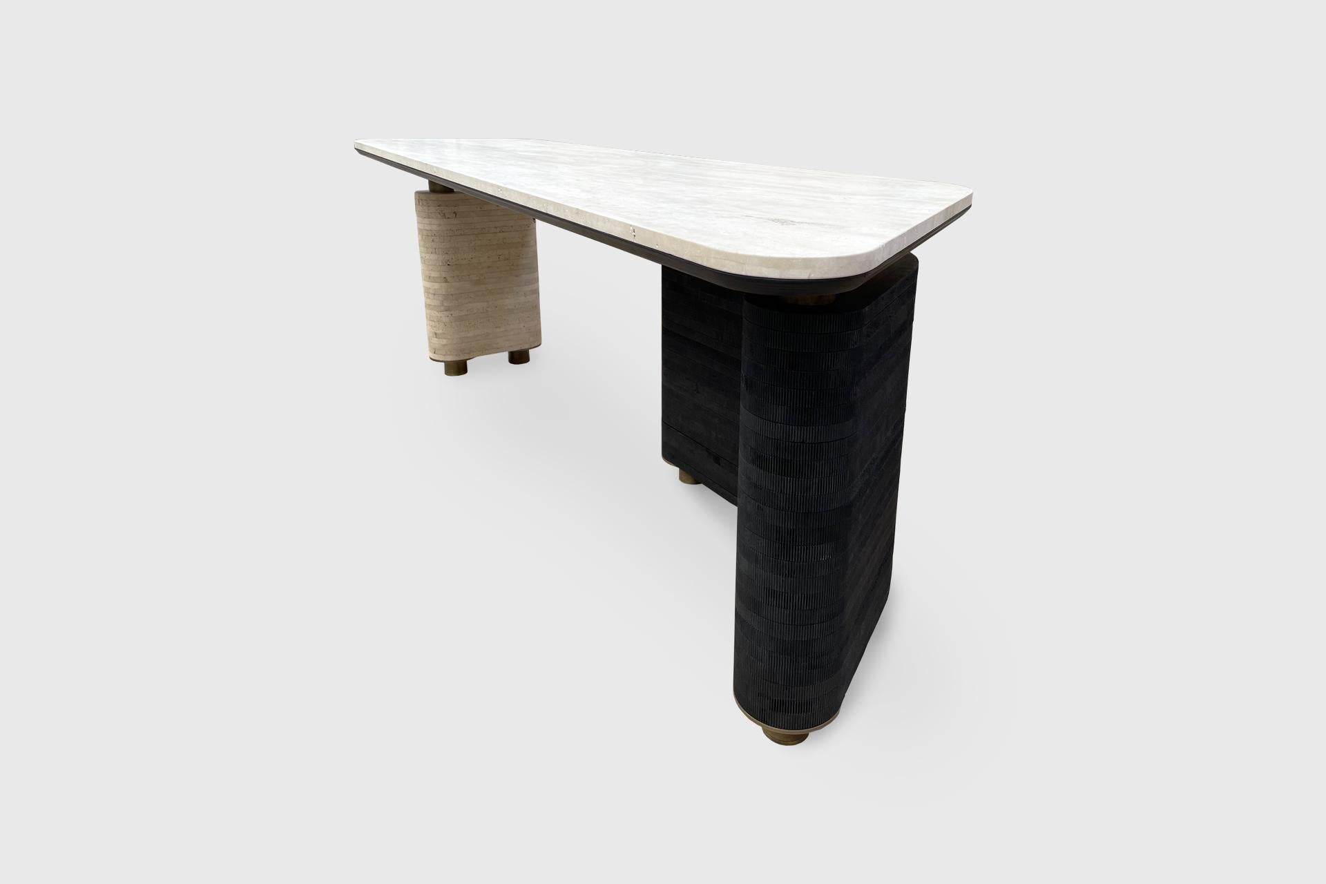 The S3 Desk in Stone top, Leg #1 Stacked Stone, Leg #2 Stacked Textured Wood and Brass Detail by Alexander Diaz Anderson

Dimensions: 
L 215.0cm/84.6”
W 75.0cm/29.5”
H 77.0cm/30.3”

Stone Options:
Verde Tikal
Negro Monterrey
Silver Travertine
Ocean