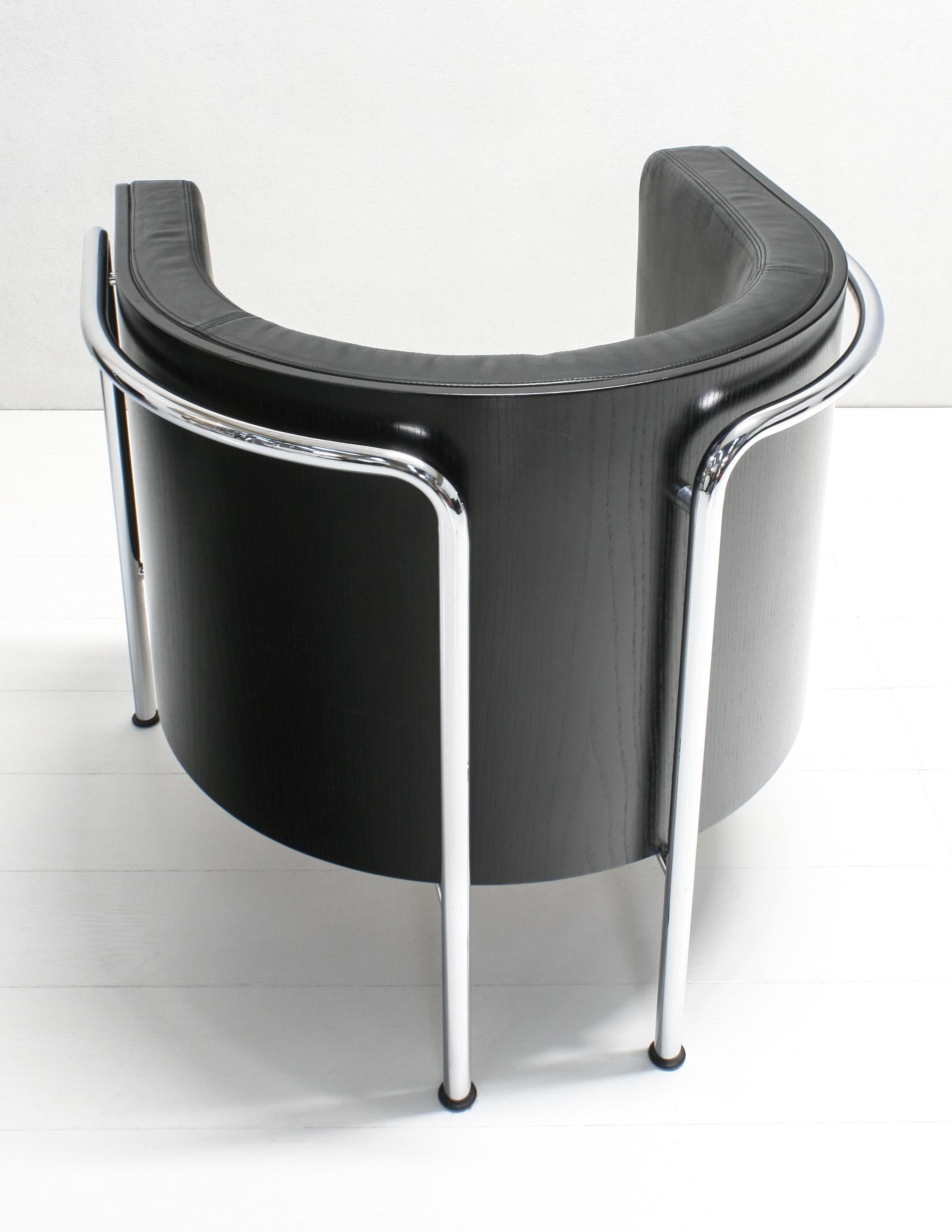 A stylish comfortable, heavy club chair model S3001 designed by Christoph Zschocke in 1990s and produced by Thonet Germany. The soft black leather upholstery is surrounded by bent black stained beech plywood and supported in a chromed frame of