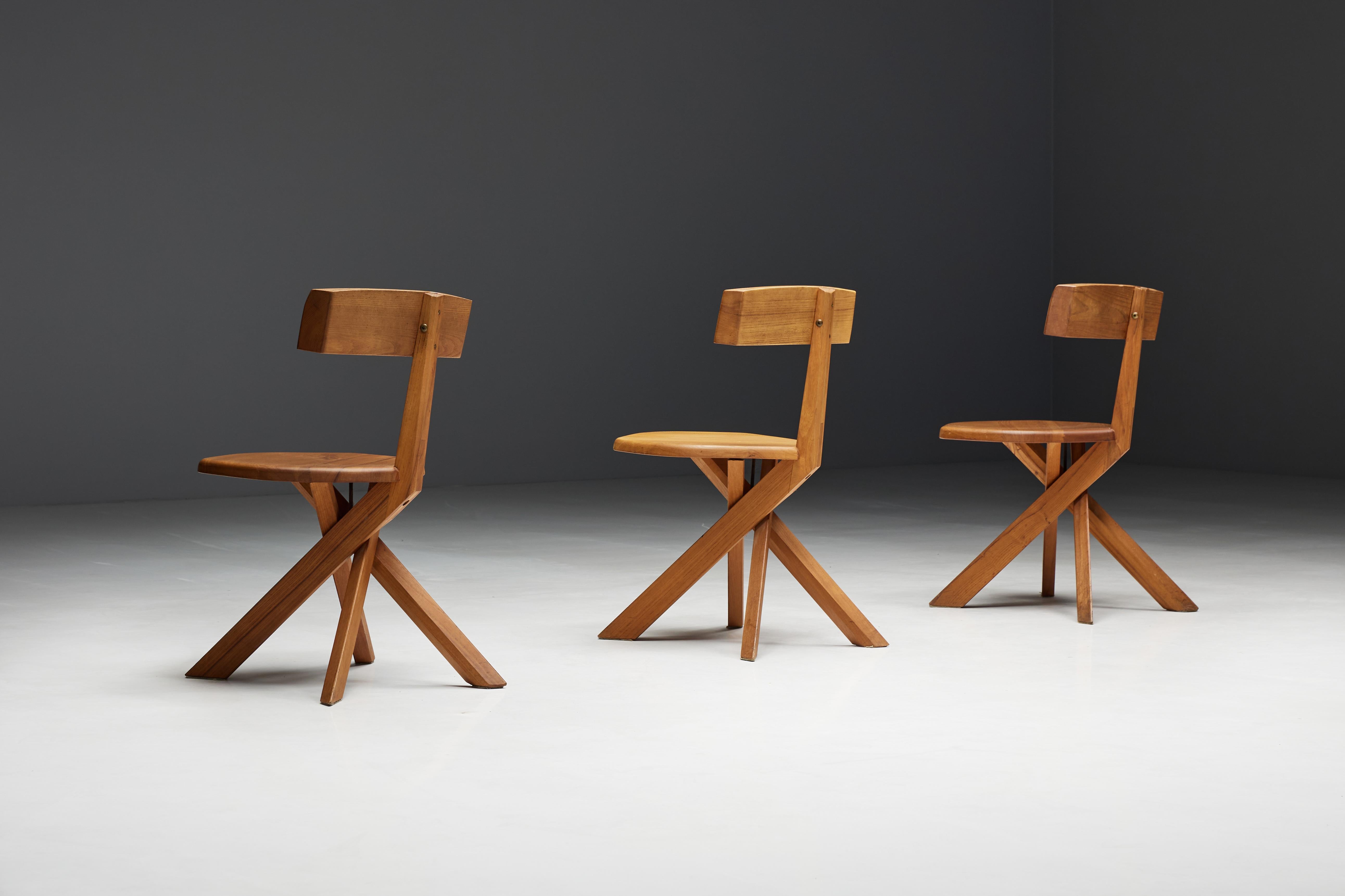 Pierre Chapo S34 dining chairs from 1970s France. These chairs embody the unique aesthetic typical of Pierre Chapo's iconic designs. The chairs' distinctive cross base harmonizes beautifully with the backrest, which is subtly positioned slightly