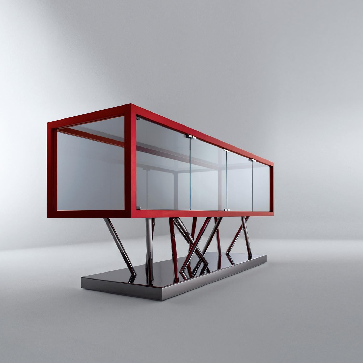 This sideboard sits atop a polished steel base and is trimmed in red aniline stained maple. It features four hinged doors, while its sides, rear panel and top are in ultra clear glass. Satin glass is available on request. SA 02 is a sculptural piece