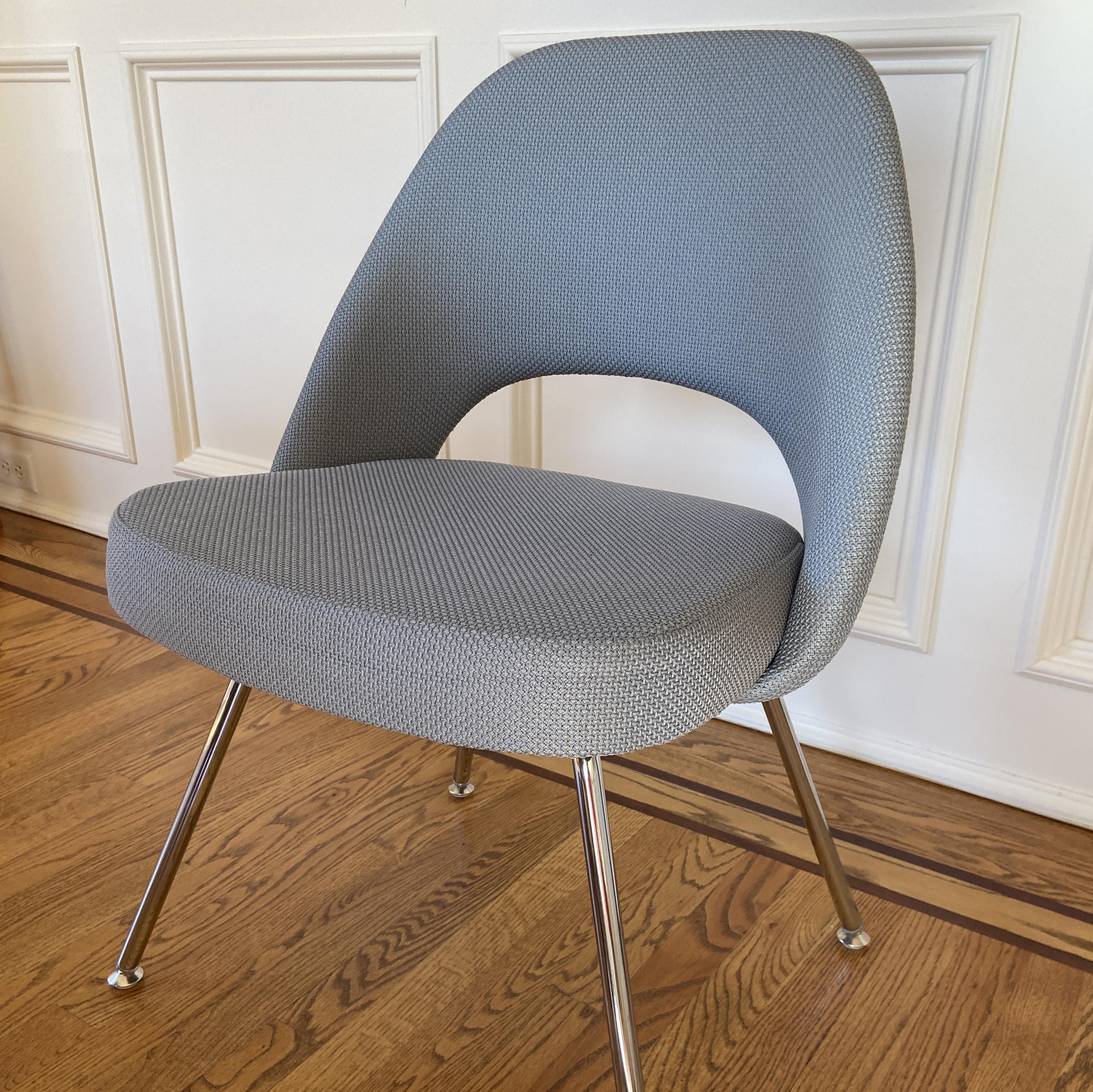 100% authentic Eero Saarinen for Knoll Executive Armless Chair recently reupholstered.  Featuring chrome tubular legs in excellent condition. We have 6 available in this handsome, durable gray fabric. Suitable for any room in the house or office. 