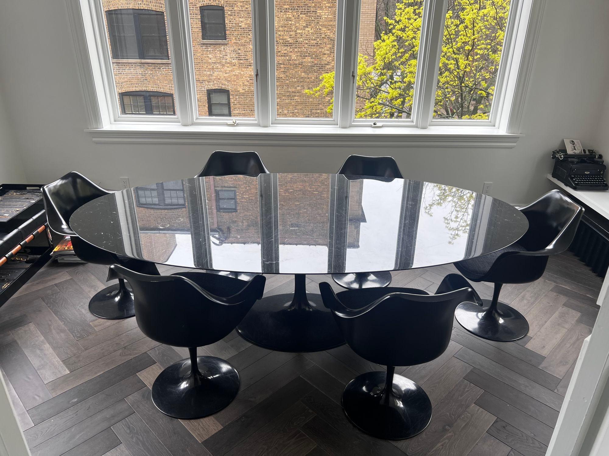 Saarinen for Knoll Black Nero Marquina marble tulip base oval dining table and 6 chairs. Newly reupholstered cushions in a gray charcoal weave . Chair dimensions 32