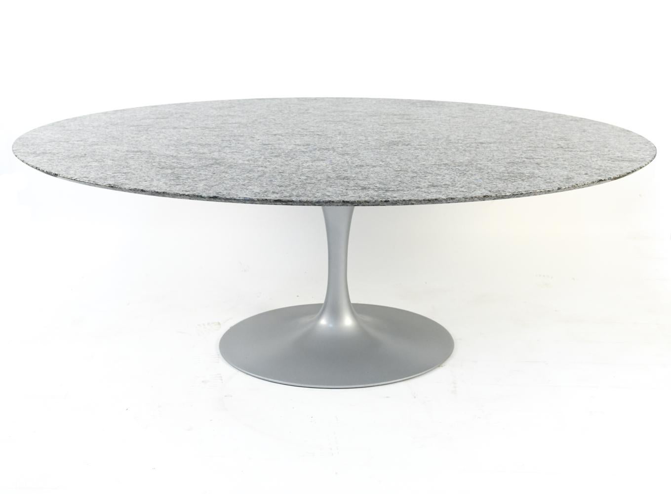 In the classic tulip form, this dining table was designed by Eero Saarinen and produced by Knoll as part of the 50th Anniversary collection, sporting the Knoll label underneath. This particular tables features a silver-tone tulip base with an oval