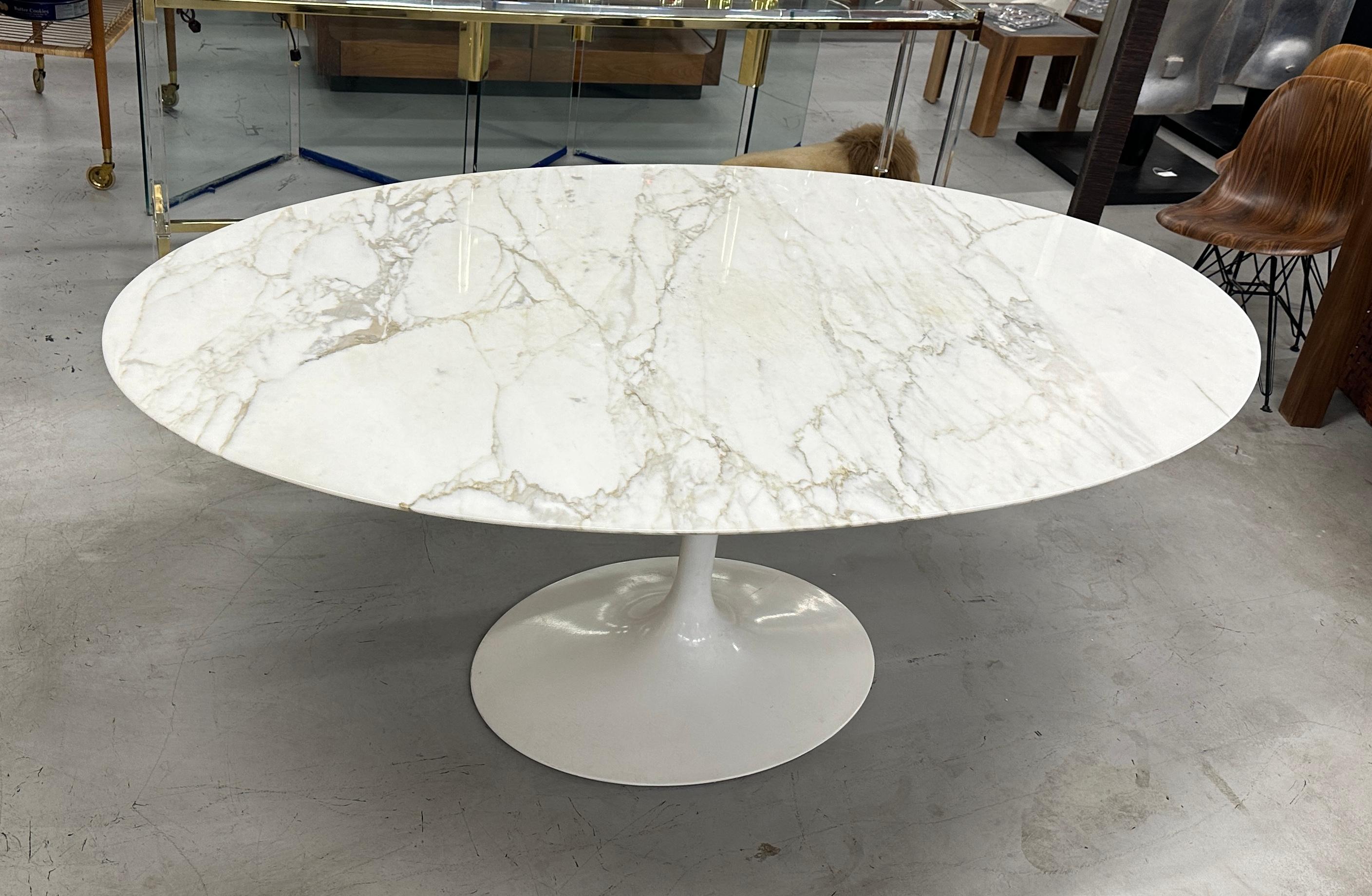 A stunning marble top 78 inch oval Saarinen Tulip table by Knoll. We purchased 2 1960's era 78 inch table's with only one vintage base. We managed to find a 1990's era Genuine Knoll base and mated it to this top. A 100% genuine Knoll table with a