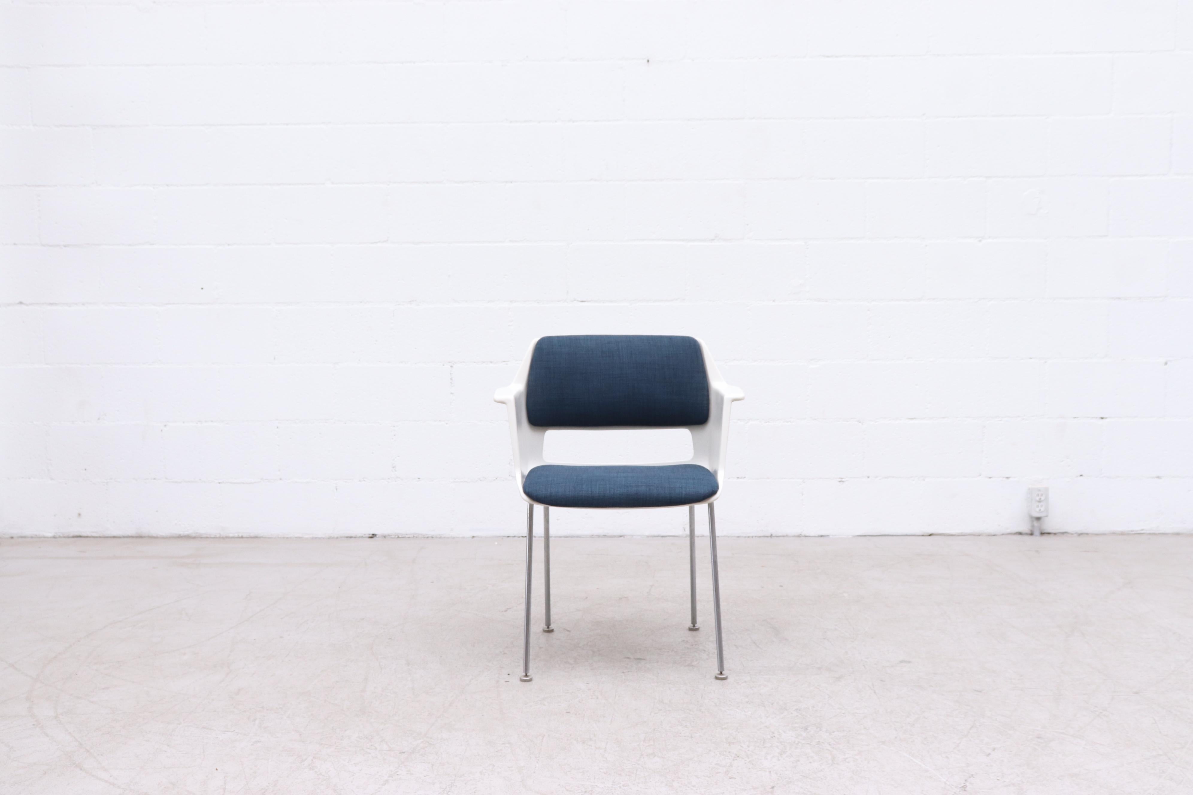 Attractive Gispen arm chair with new blue upholstered fabric, molded acrylic frame and tubular metal legs. In original condition with wear consistent with its age and use.