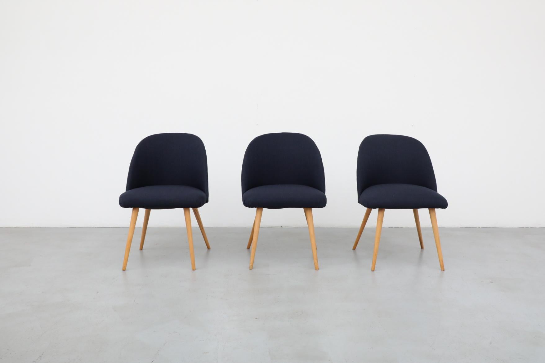 Elegant, Saarinen style Mid-Century accent or cocktail chairs with natural birch tapered legs and new blue fabric. In otherwise original condition with visible wear consistent with its age and use. Sold individually. Many similar chairs available in