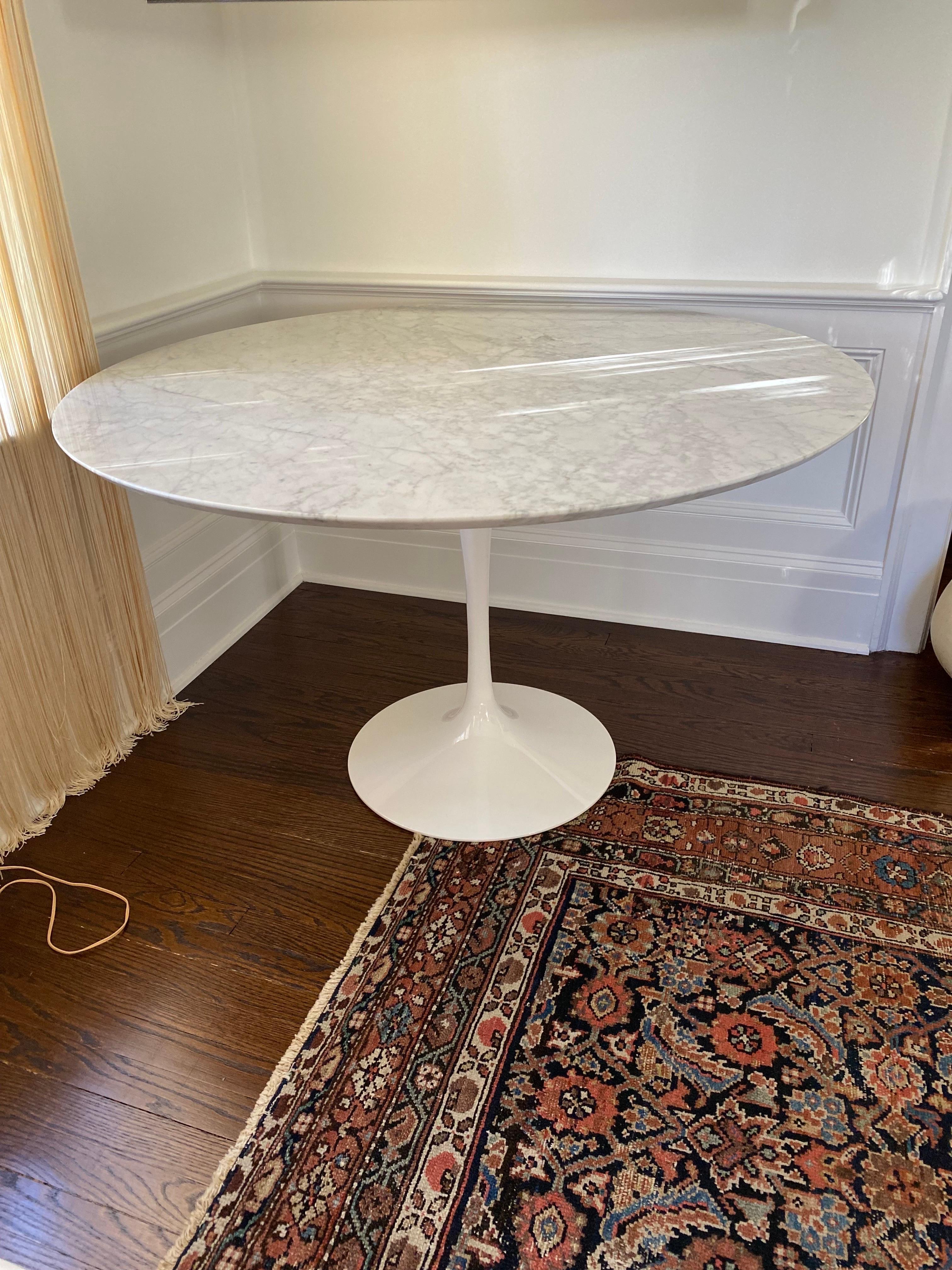 Saarinen Style Tulip Table With Carrera Marble Top (with chip).
The classic Saarinen Tulip Table in white steel base, unmarked so suggested in the style of.  Beautiful carrera marble top, one chip on edge, otherwise light wear throughout.

47.38