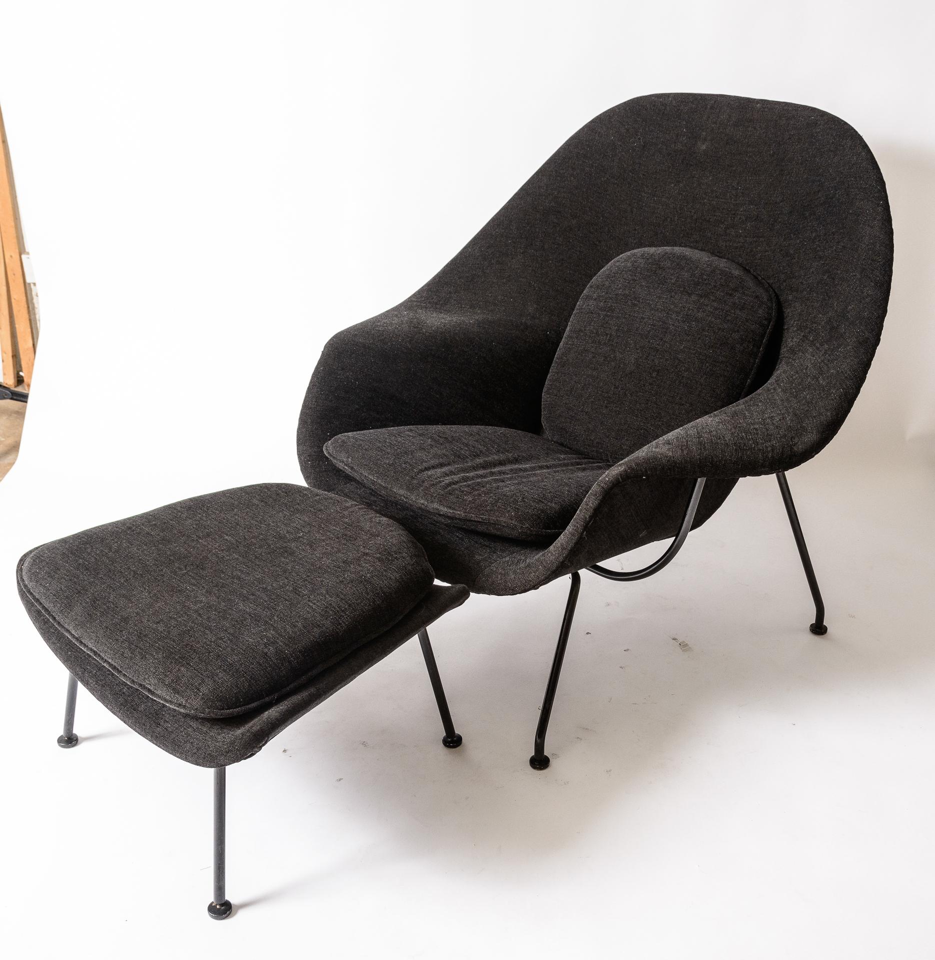 Eero Saarinen Womb Chair and Ottoman
Late 1960s production by Knoll
 Re-Upholstered
Original Black Enamel Frame
Color of the fabric is black with gray undertones, the 
last photo ,I have place a gray and black t-shirt against the cushion