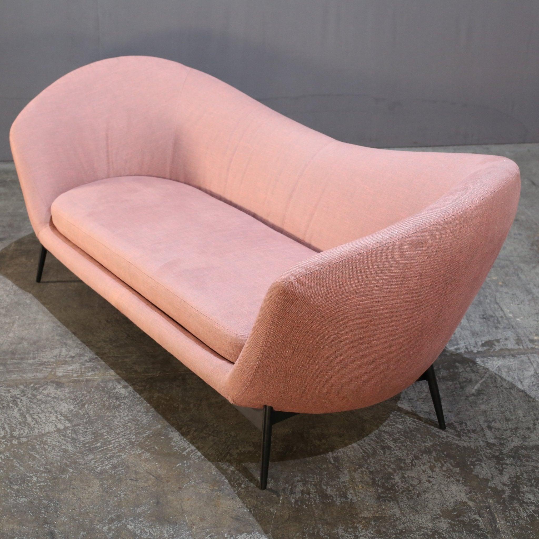 Introducing the stunning Oltremare Sofa by renowned designer Antonio Marras for Saba Italia. This luxurious piece features a unique curved design, creating a sense of movement and fluidity in any space. The sofa is expertly crafted with high-quality