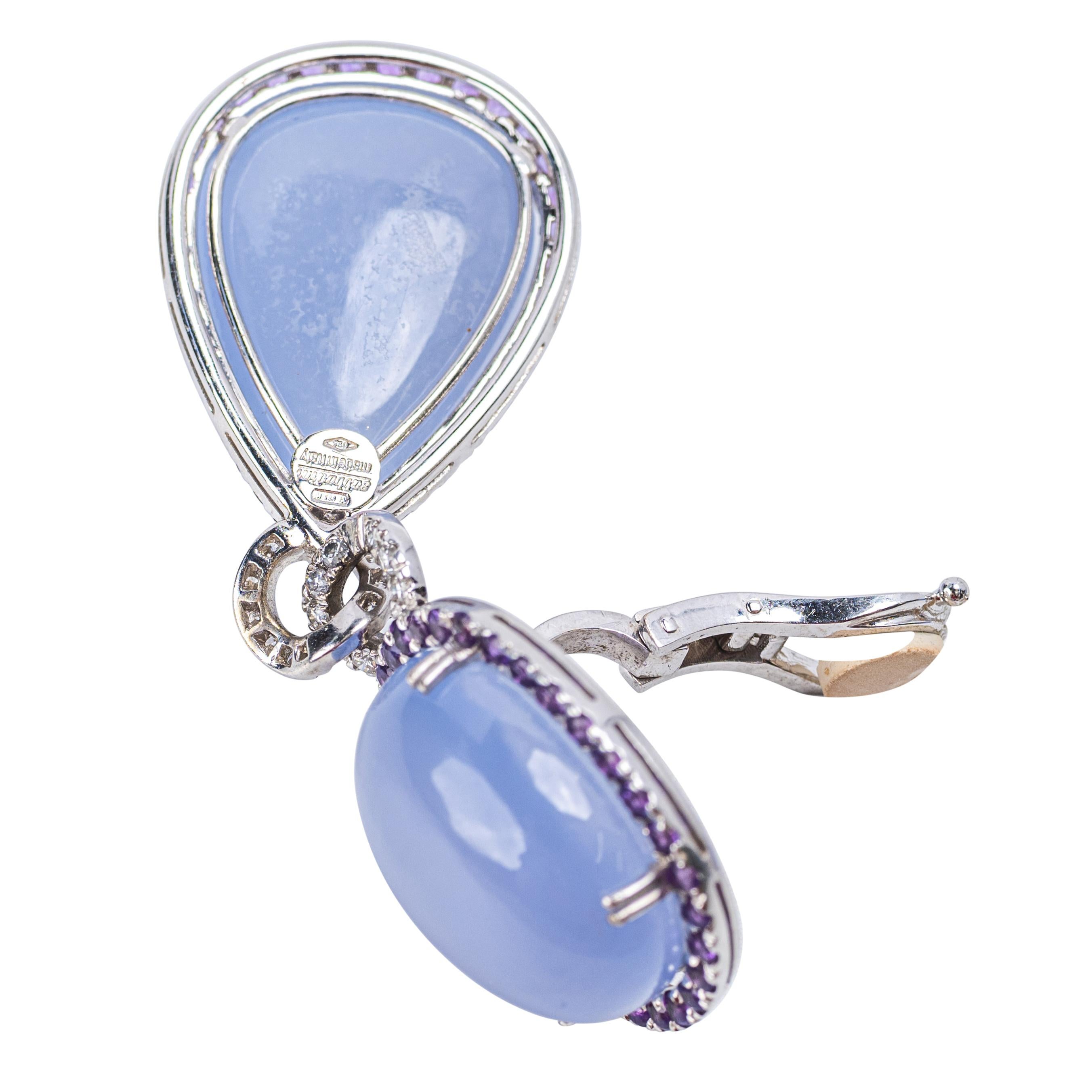 Sabbadini 18K White Gold Chalcedony, Amethyst and Diamond Drop Earrings



A striking pair of earrings by Sabadini, Milan, featuring luscious lavender chalcedony cabochons framed by round-cut amethysts and joined by pavé-set white diamond