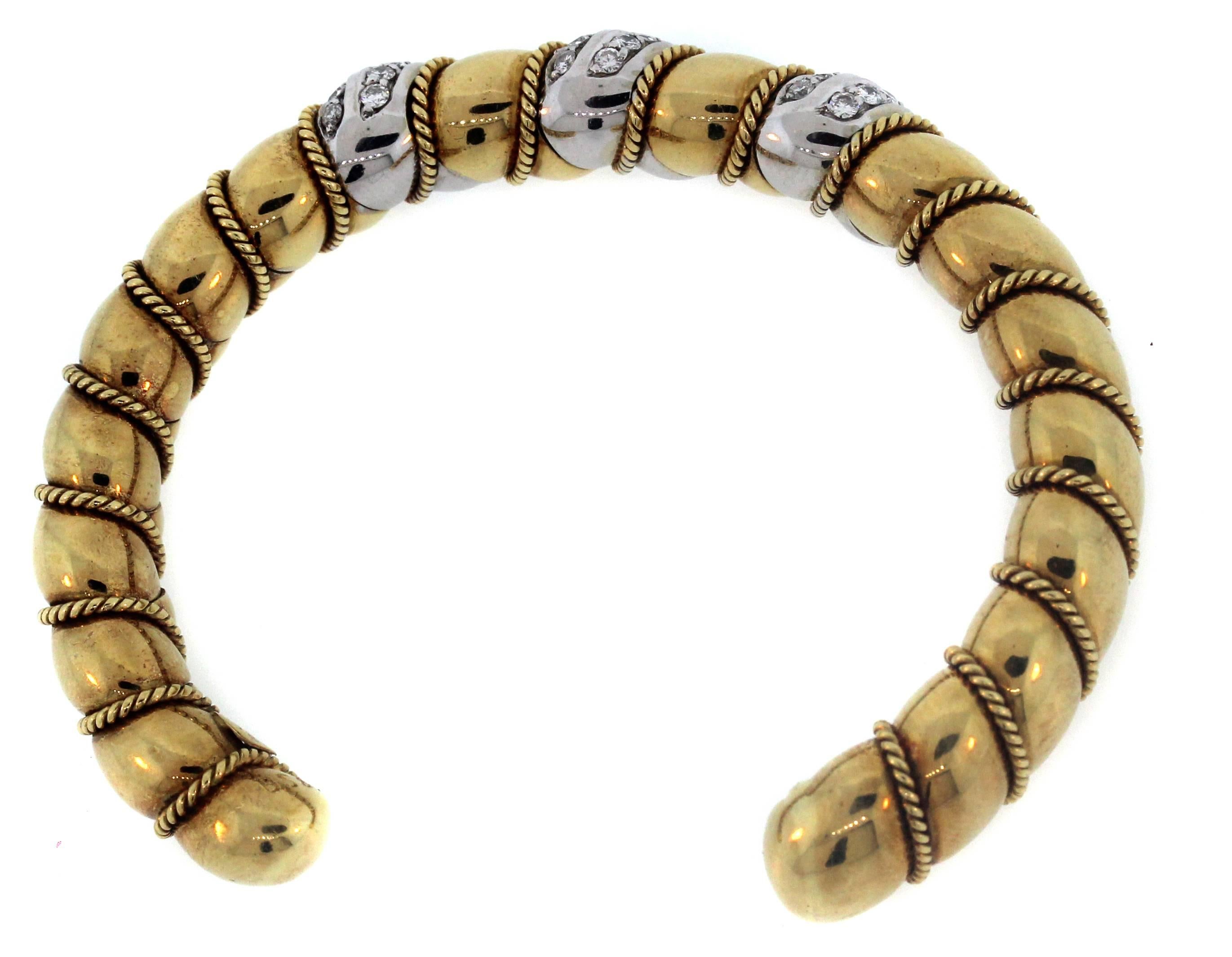 Sabbadini 18K Yellow White Two-Tone Gold Diamond Twisted Style Bangle Bracelet

Gorgeous craftsmanship and detail seen throughout the piece. 

1.05 carat Diamonds G Color, VS Clarity

Size 6. 

Bracelet is 0.35 inch width. Bracelet is slightly