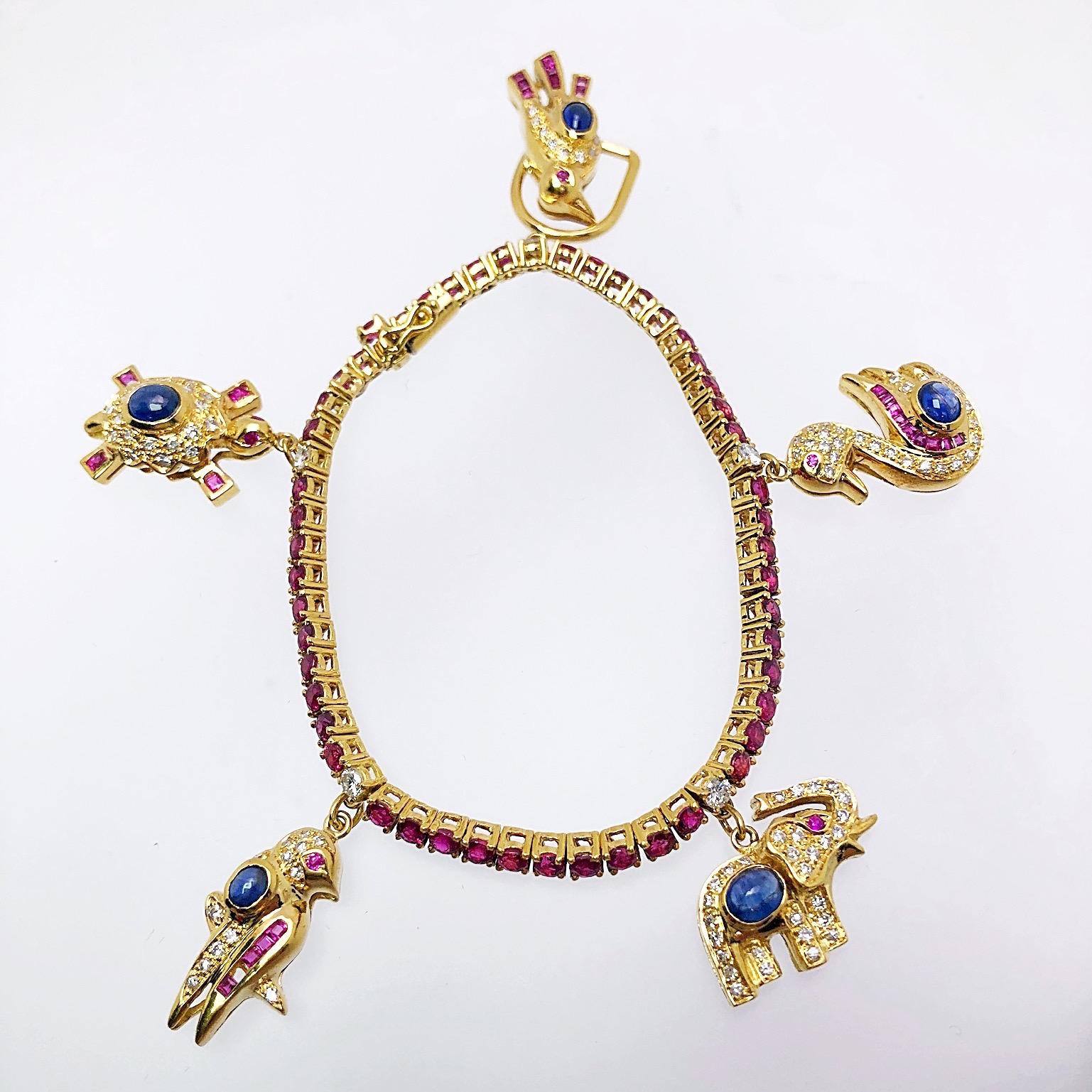 Created by the famed jewelers Sabbadini of Italy, this 18KT yellow gold charm bracelet is is quite the unique piece. The 1.72CT. Ruby bracelet is adorned with various animal charms, each detailed with diamonds, invisibly set rubies, and cabochon