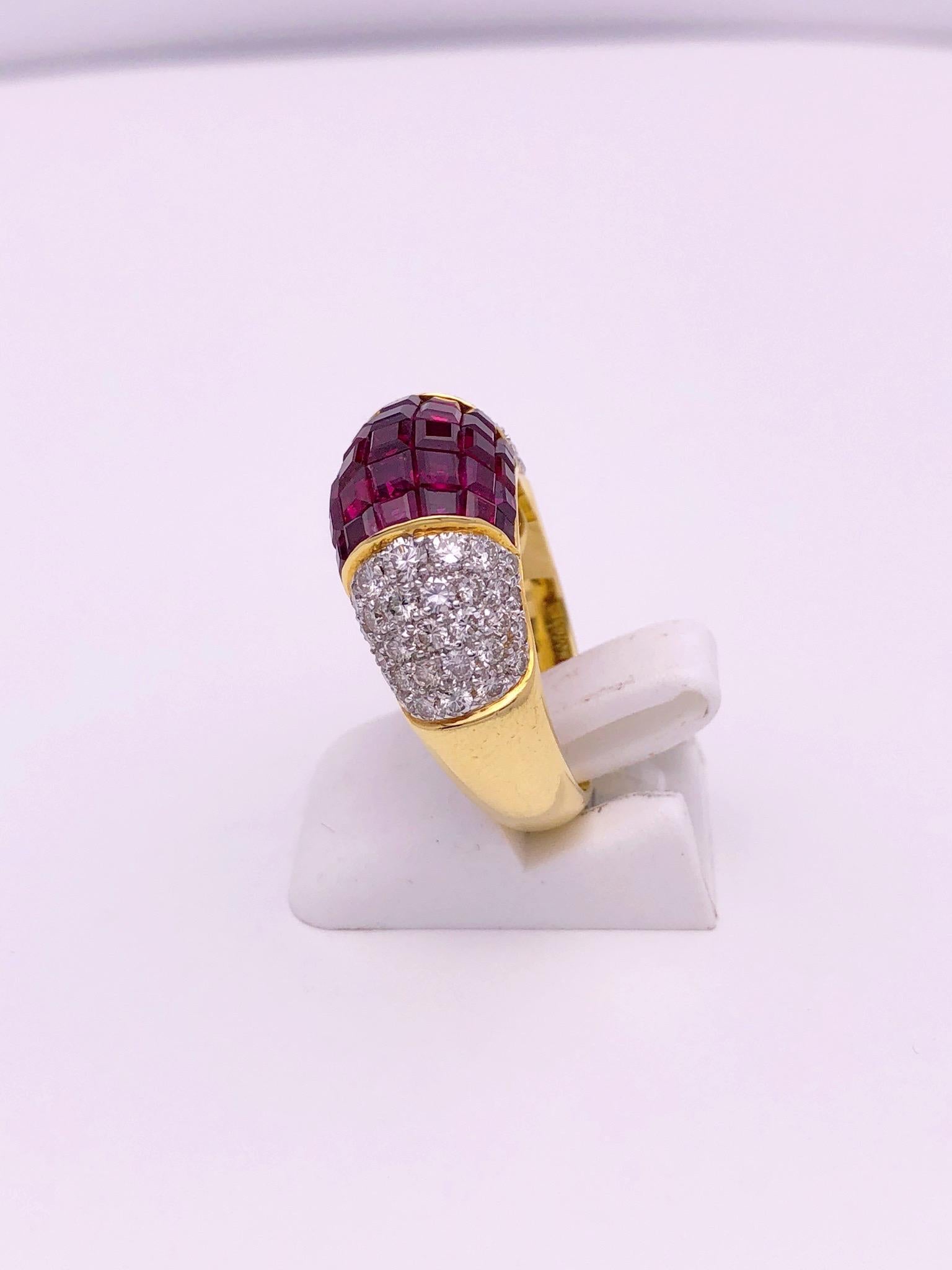 Created by the famed jewelers Sabbadini of Italy, this 18kt yellow gold ring is in their classic style. Vibrant invisibly set square cut Rubies are the center piece of this domed ring, along with pave Diamonds on either side.
Total ruby weight 4.90