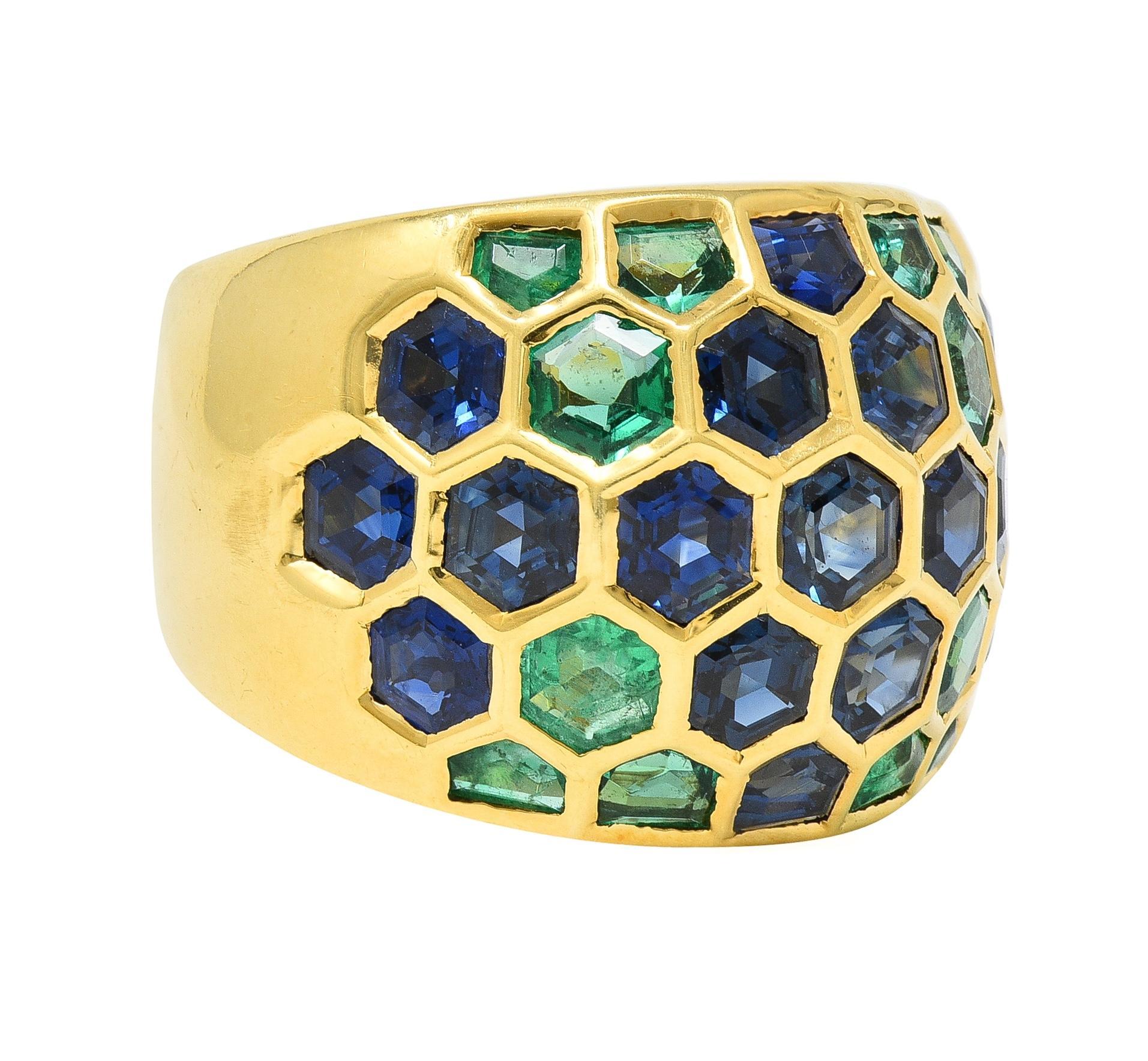Designed as a domed gold form featuring flush set hexagonal shaped emeralds and sapphires
Emeralds weigh approximately 1.71 carats total - transparent medium green
Sapphires weigh approximately 4.76 carats total - transparent dark blue
With wide
