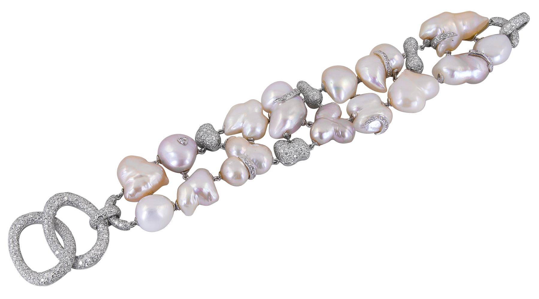 Sabbadini Diamond Pearl Bracelet Earrings Suite in 18k White Gold.

This Italian suite features baroque pearls that stagger organically-shaped baubles of diamond-pave. Fluidity in movement is the best way to describe both pieces when worn. The