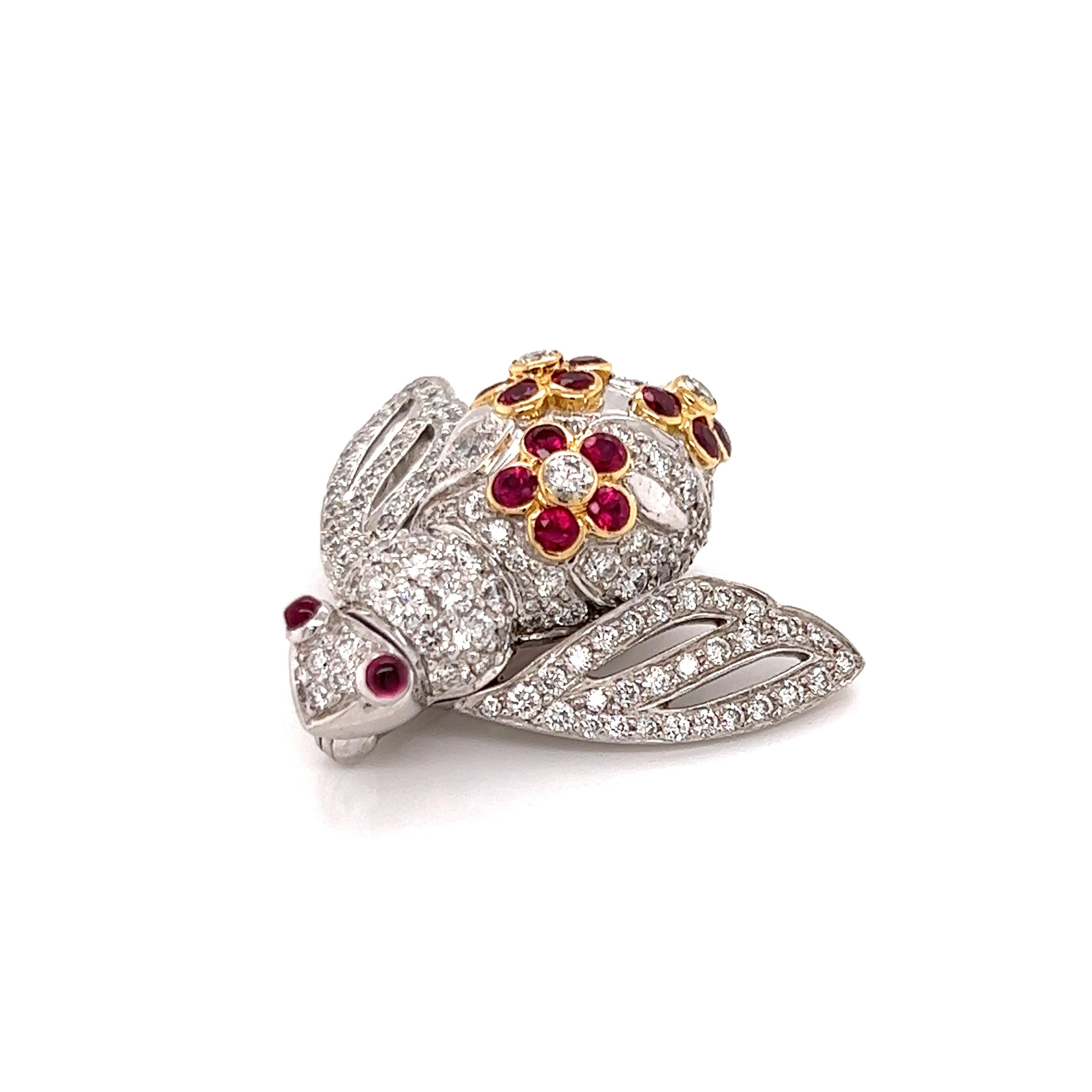 This eye-catching authentic bee brooch is by Italian designer Sabbadini, it is crafted from 18k white gold with yellow gold accent. The body and wings of the bee is fully decorated with diamonds, the eyes are two small cabochon rubies. On the back