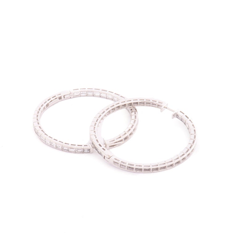 The perfect pair of 18kt gold and diamond hoops!

6,82 carats of white baguette cut diamonds F/G color, set inside and outside the hoop for maximum sparkle!