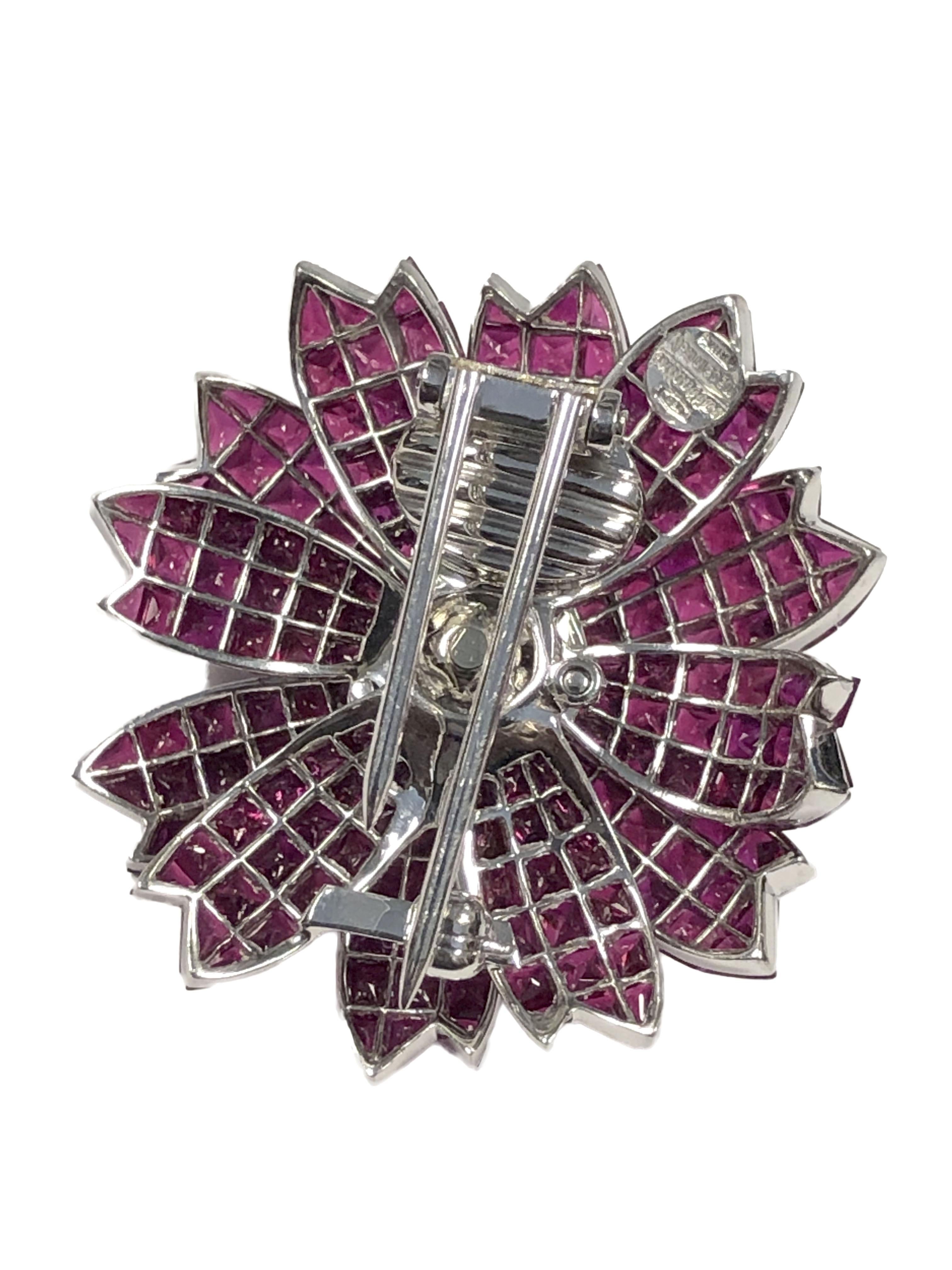 Sabbadini of Italy 18k White Gold Flower form Brooch, measuring 1 3/8 inches in diameter, Invisibly set with very Fine Bright Gem color Burma Rubies totaling approximately 30 Carats and further set with Round Brilliant cut Diamonds totaling 1.25
