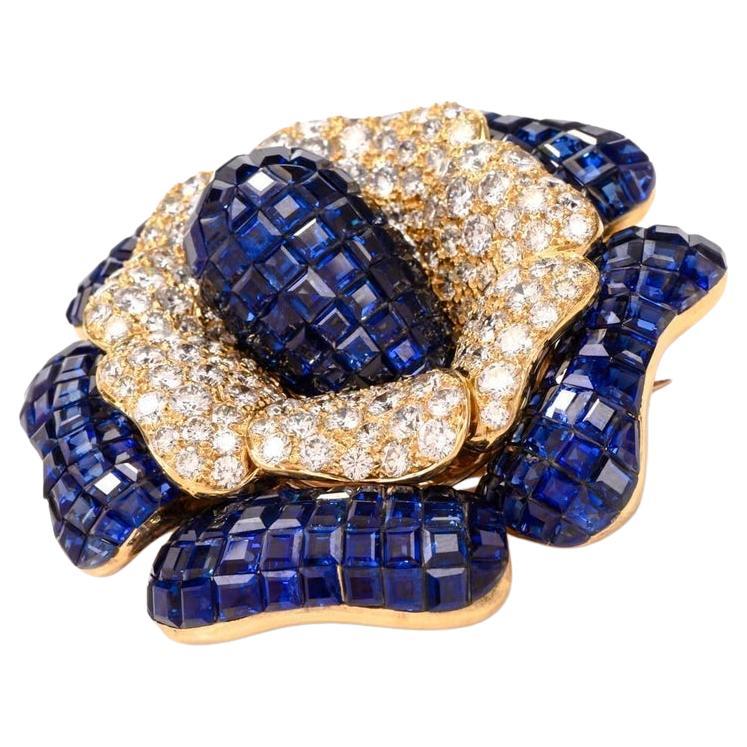 This outstanding Collectable flower brooch pin was designed by Sabbadini, Italy. It is handcrafted in solid 18K yellow gold weighing approx. 69.9 grams. It features a flowerhead design of bombé calibrated step-cut high quality royal blue genuine