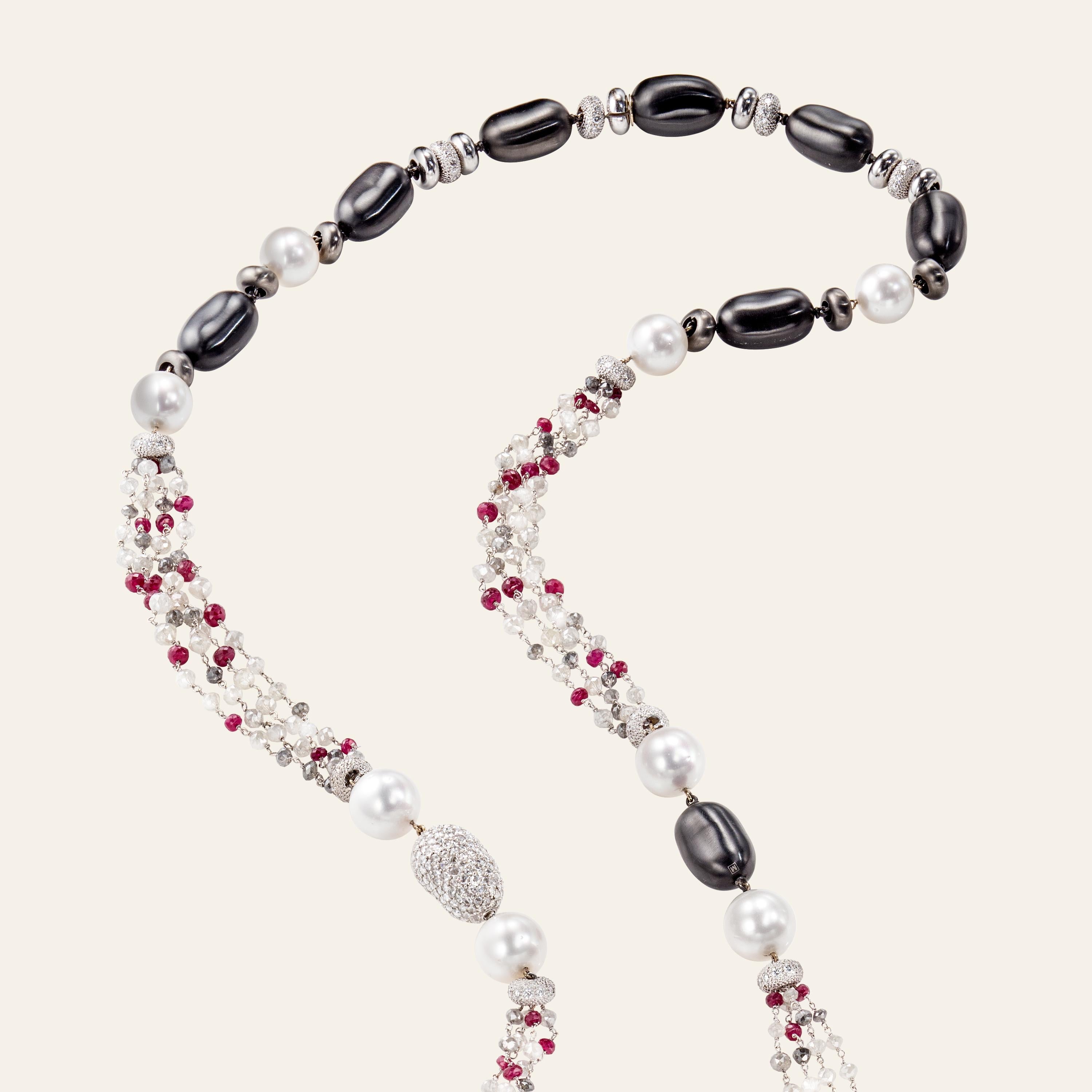 Sabbadini Jewelry Long Necklace With Pearls, Diamonds & Rubies
Long bead necklace, 18k white gold rondellas, black steel pebbles, 'south-sea' pearls, briolette diamond beads 82,48 carats, faceted ruby beads 24,63 carats, round cut diamonds 14,47
