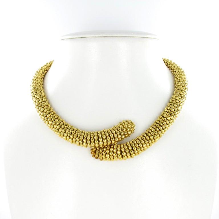 This beautifully soft and timeless parure in 18 karat yellow gold by Italian jeweler Sabbadini consists of a necklace, bracelet, and a pair of earclips. Each piece is carefully crafted, so that it literally flows around neck and wrist. Decorated