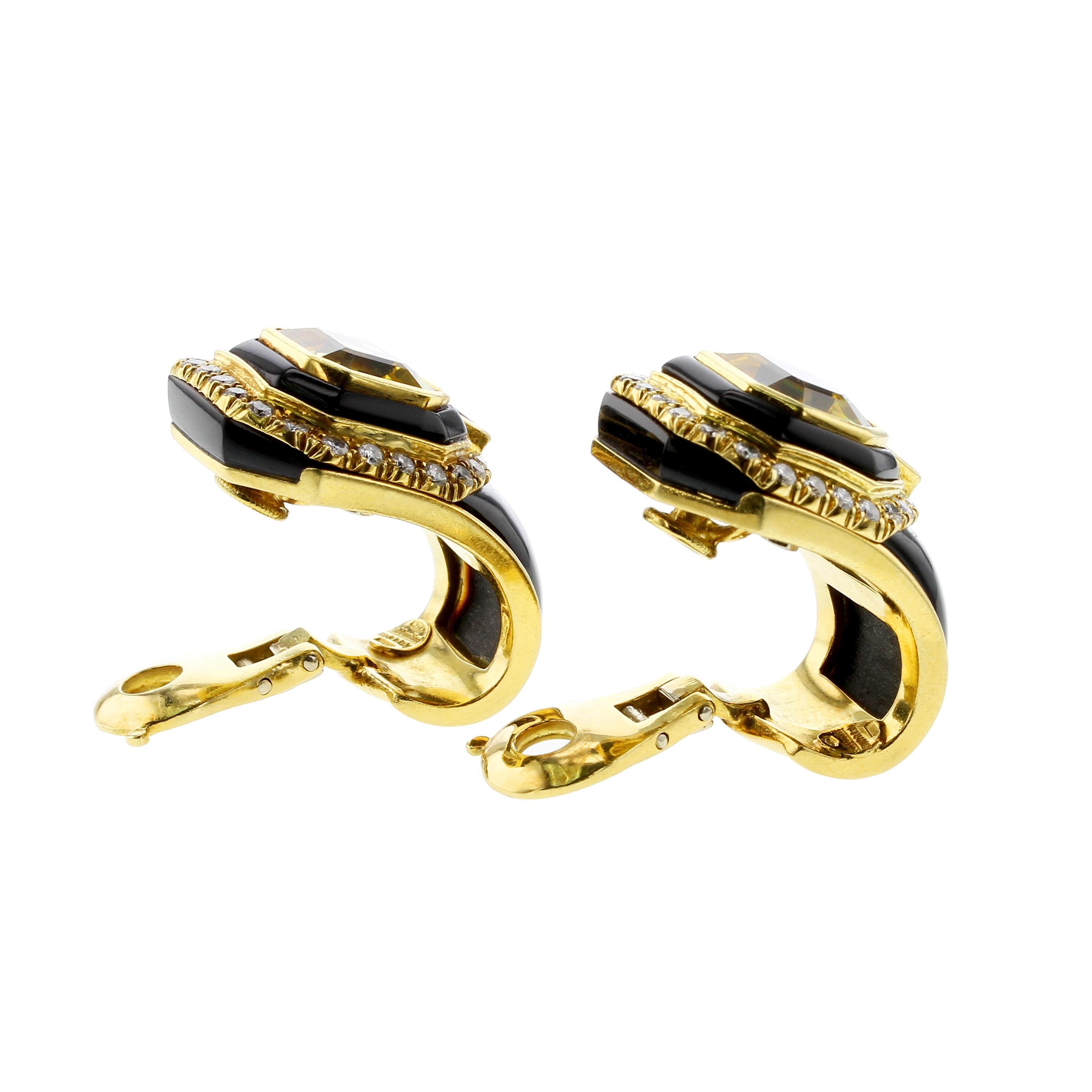 An elegant and beautiful pair of octagonal shape step-cut yellow sapphire clip-on earrings set in 18kt yellow gold. Each sapphire weighs approximately nine carats, bordered with black onyx, and further clustered with white round, brilliant-cut