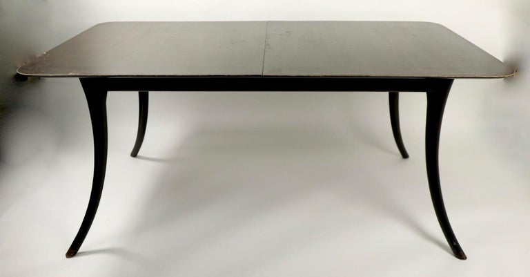 Iconic Robsjohn Gibbings for Widdicomb saber leg dining table. This table has great chic lines, and the sophisticated style expected from RJG. This example is structurally sound and sturdy, but will need to be refinished, leaves not included. Table