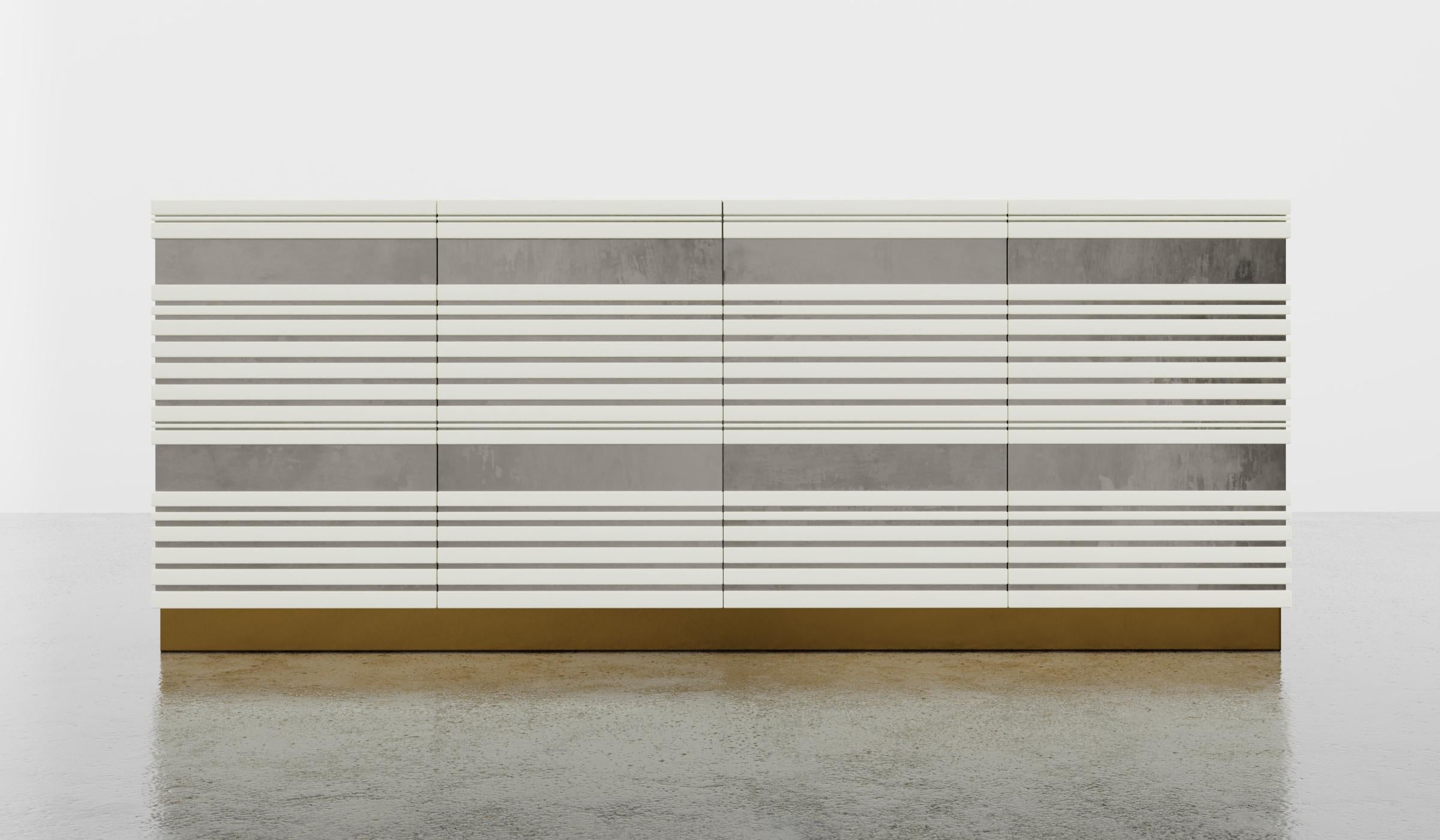 SABINE CREDENZA - Modern Linear Body and Silver Leafed Inlay with Metal Base

The Sabine Credenza is a beautiful and modern piece of furniture that features a linear lacquer body with a striking silver leaf inlay, set on a metal plinth. The standard