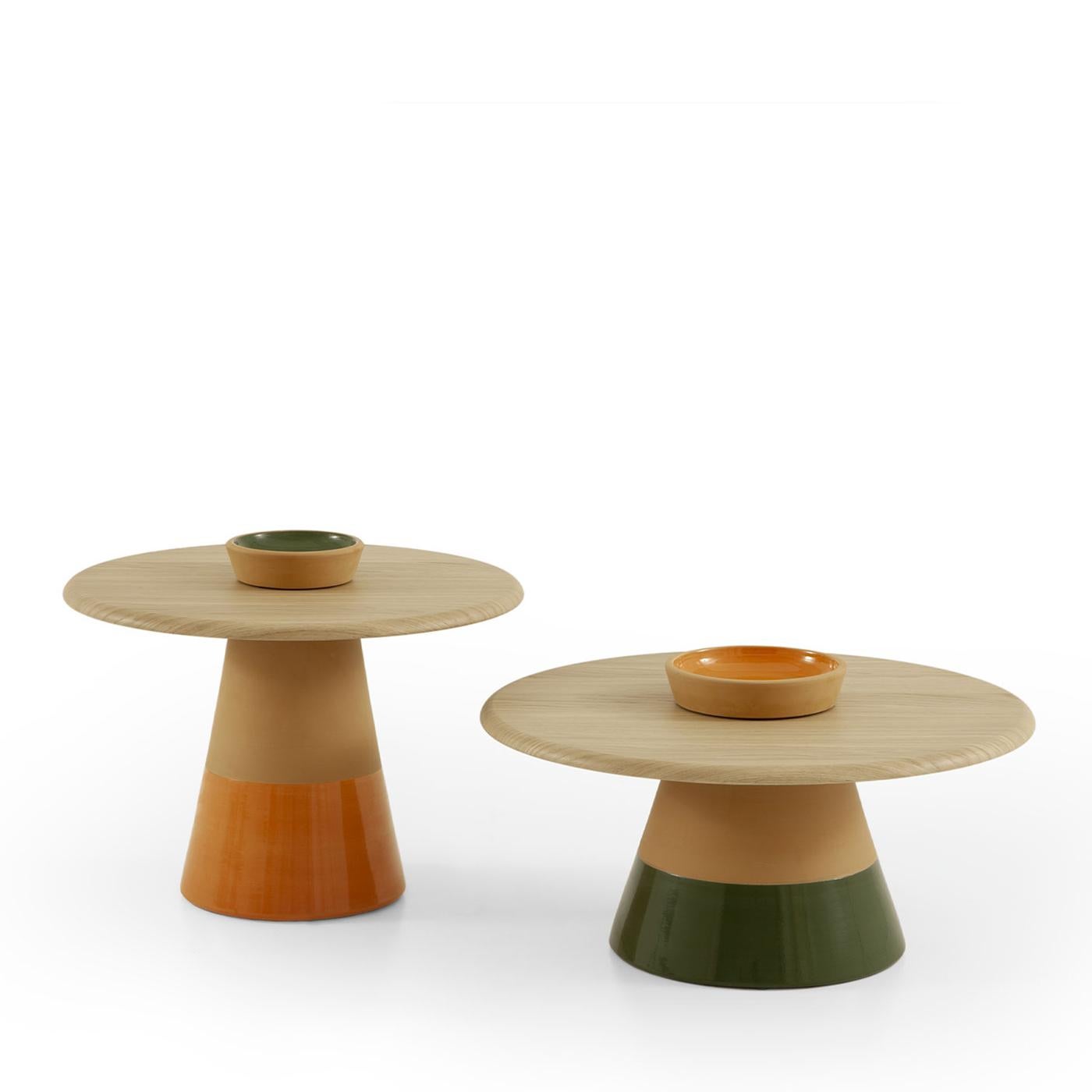 A testament to artisanal finesse, this coffee table features a base of natural terracotta clay, skillfully thrown and adorned with a glossy Mandarin orange enamel insert. Its tabletop, crafted from natural oak veneer MDF with a membrane-pressed