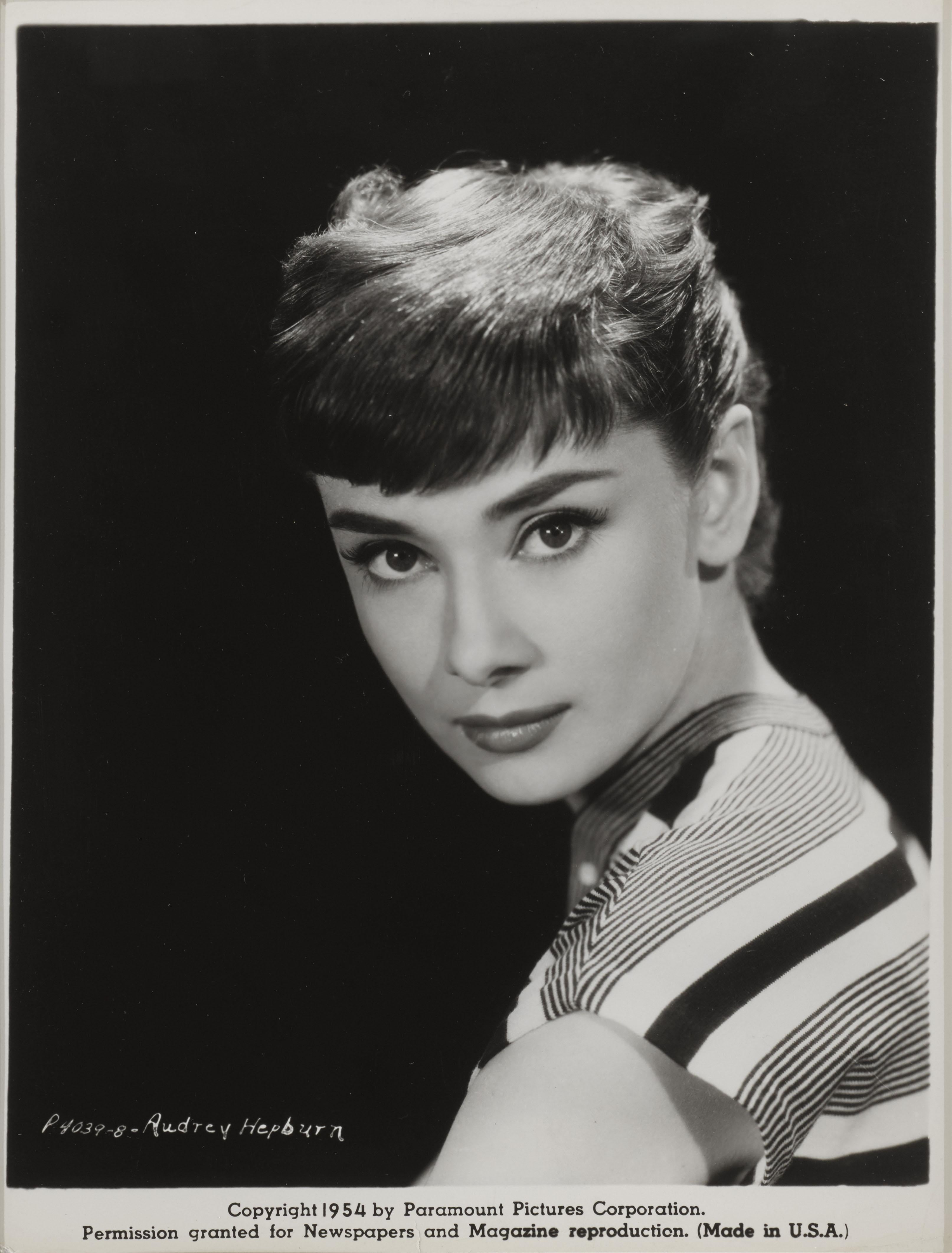 Original American promotional studio photograph  of Audrey Hepburn used to promote her up coming film Sabrina in 1954.
This film starred Audrey Hepburn, William Holden and Humphrey Bogart. This film was directed by Billy Wilder.

This photo is from