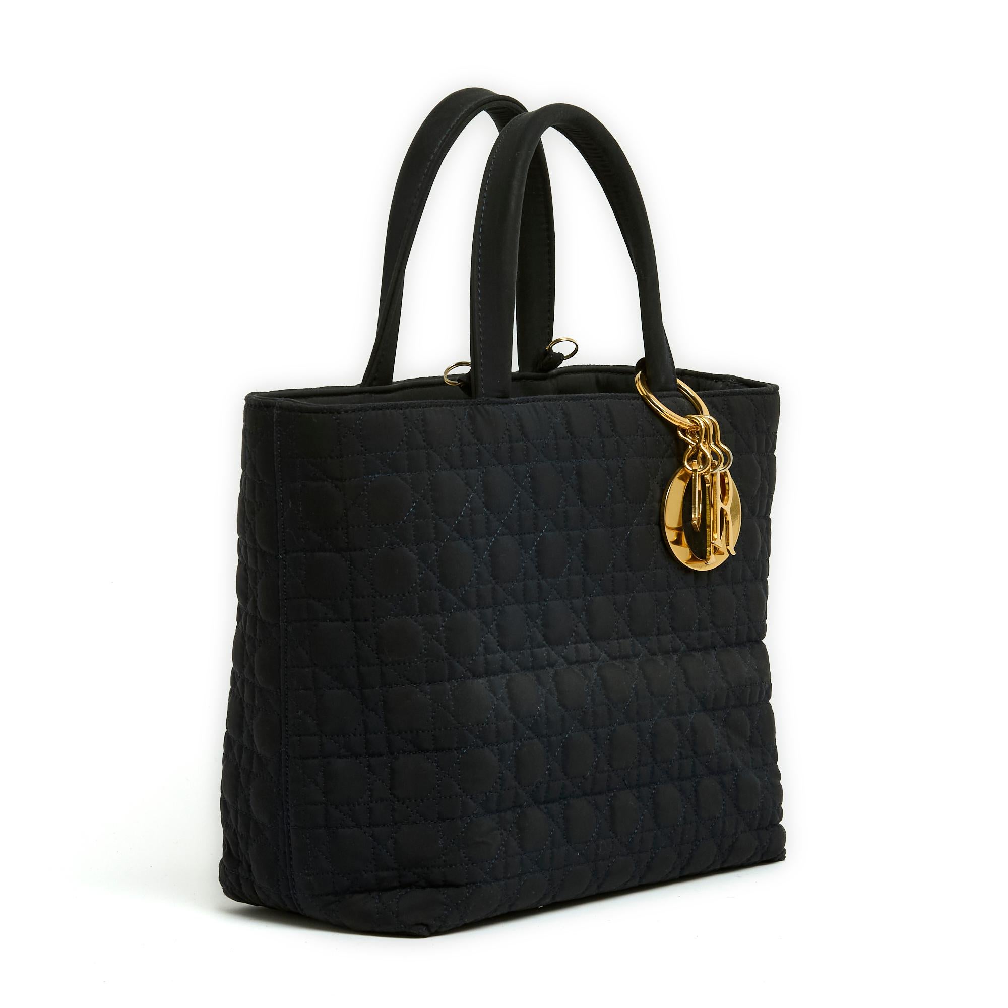 Medium Lady Dior bag in almost black navy blue quilted Cannage canvas and gold metal, Dior letters, removable shoulder strap for carrying on the shoulder or cross body, 2 rigid handles for carrying in the hand, interior in red cannage canvas with 2