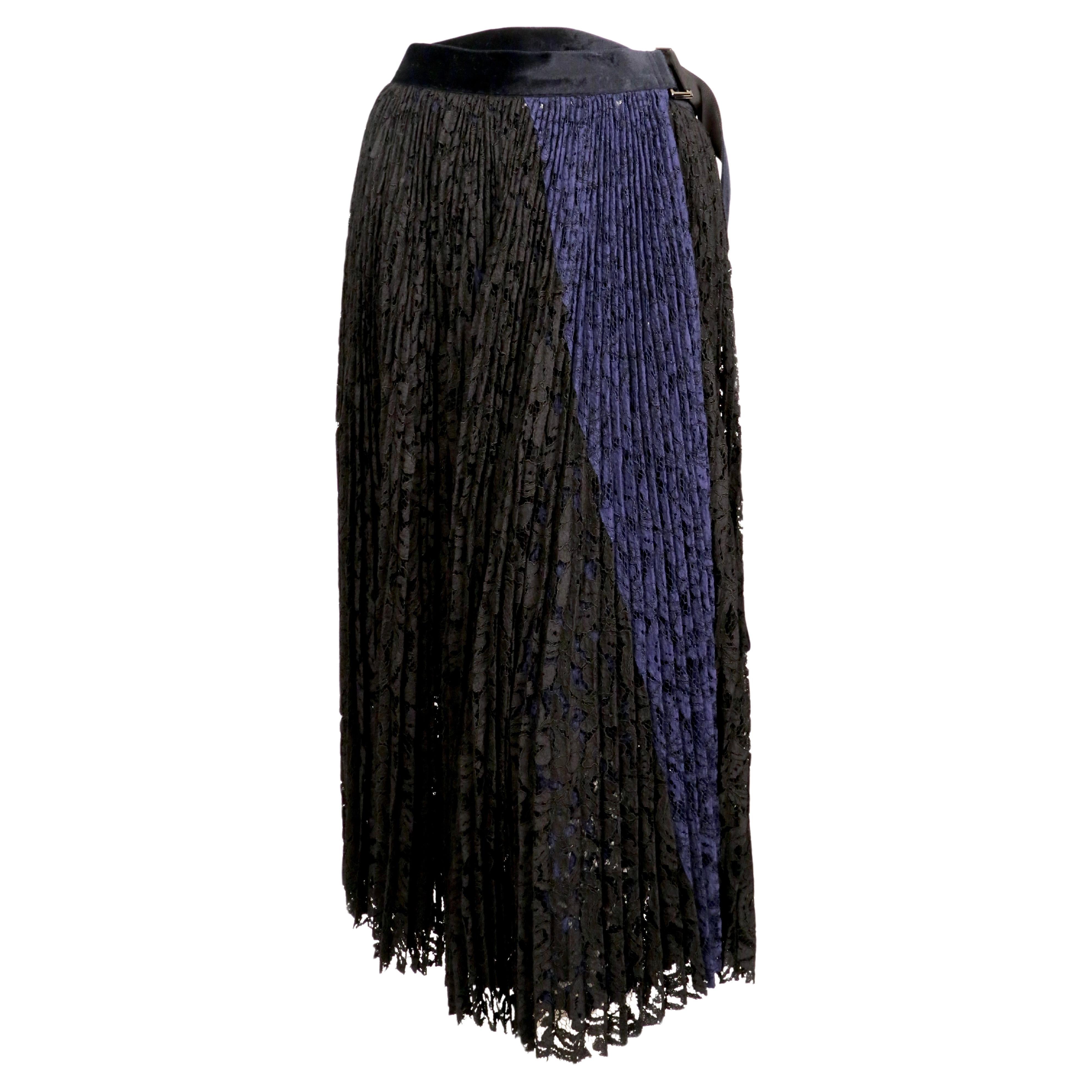 Black and blue lace wrap skirt with black slip from Sacai. No size is indicated however this is most likely a '1'. Skirt was not clipped on size 2 mannequin. Approximate measurements: length 33