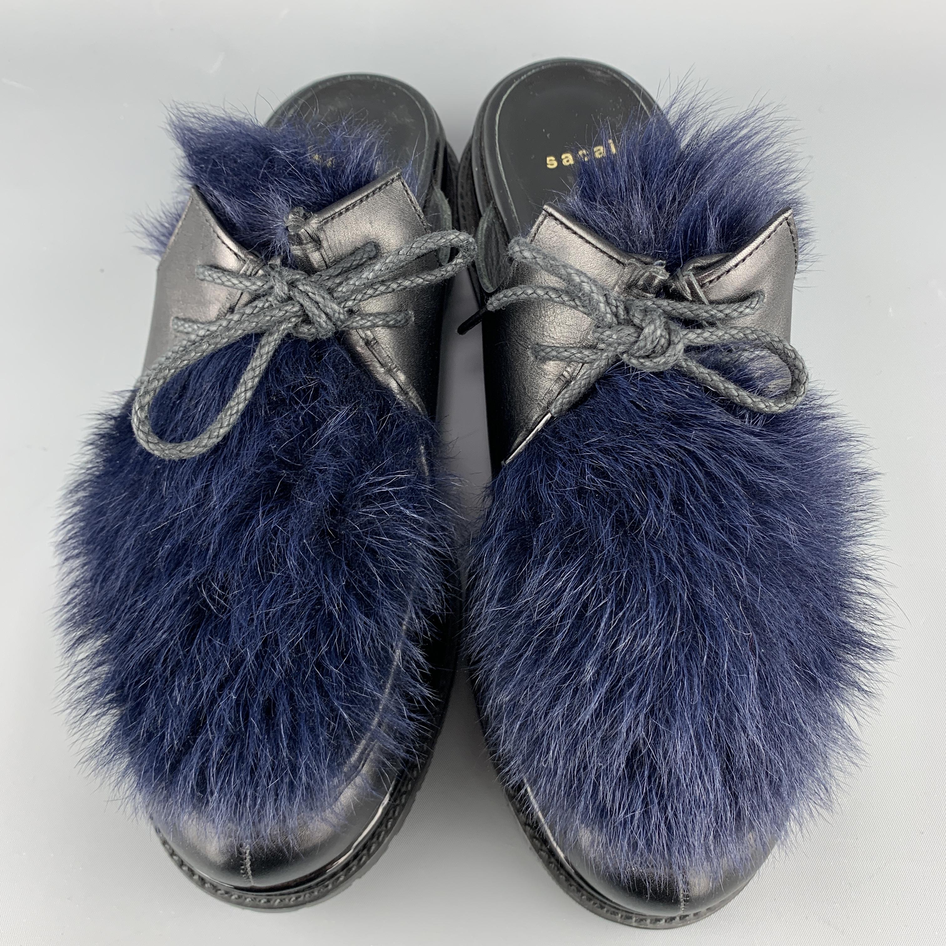 SACAI loafer slides come in black leather with a patent leather mid sole, Vibram commando sole, and navy blue fur top panel. Made in Japan.

Excellent Pre-Owned Condition.
Marked: IT 40

Outsole: 11.5 x 4.5 in.