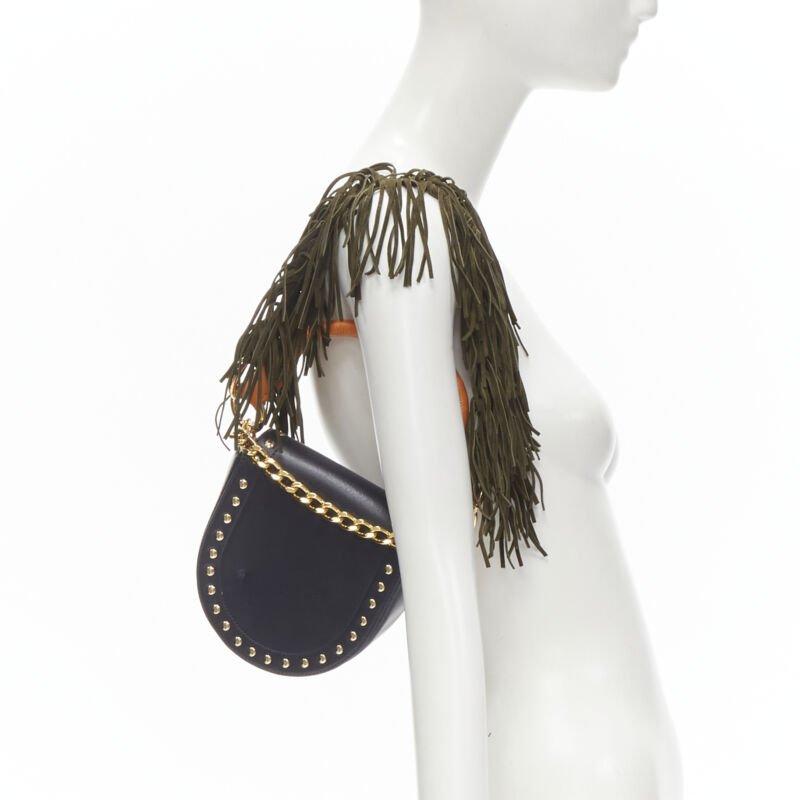 SACAI black leather gold studded fringe gold chain saddle bag
Reference: ANWU/A00032
Brand: Sacai
Designer: Chitose Abe
Material: Leather, Suede
Color: Black, Green
Pattern: Solid
Closure: Magnet
Extra Details: Orange rolled hande. Green suede