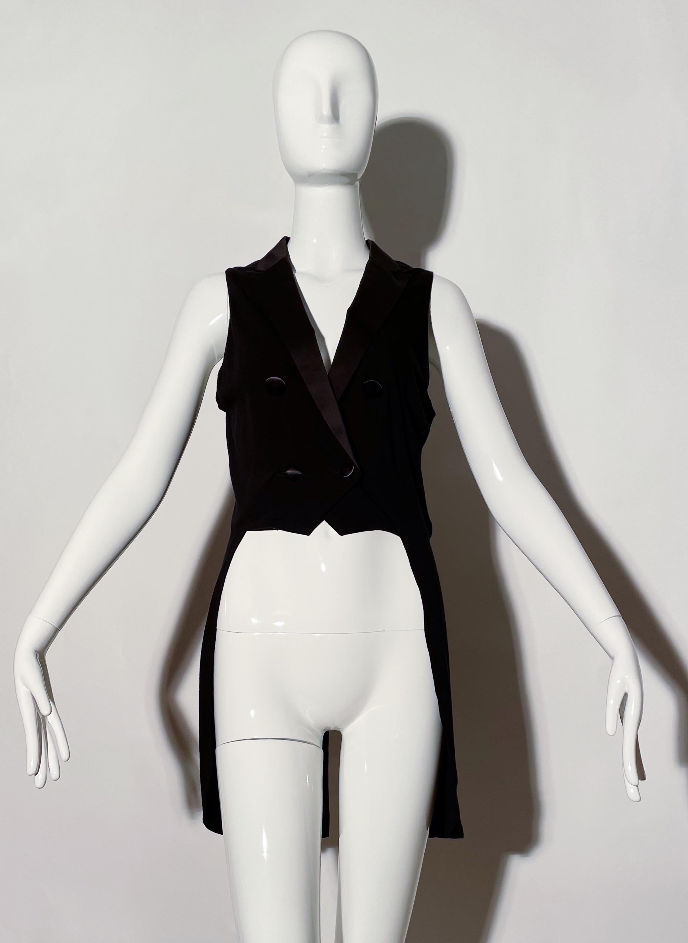 Black tailcoat vest. Satin collar and buttons. Short front, long rear. Cotton. Made in Japan. 
*Condition: excellent vintage condition. No visible flaws.

Measurements Taken Laying Flat (inches)—
Shoulder to Shoulder:  13 in.
Bust: 32 in.
Front