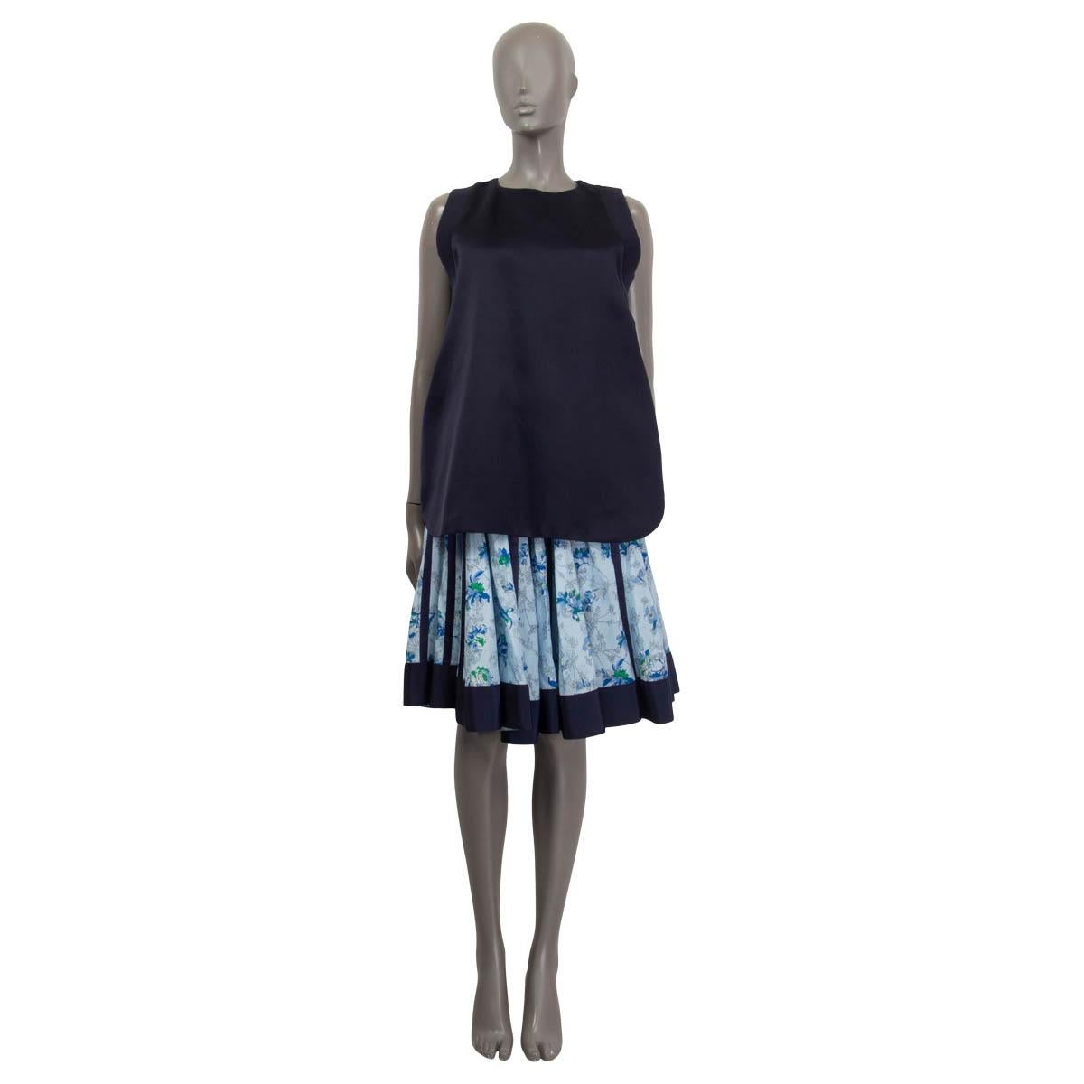 100% authentic Sacai sleeveless dress in midnight blue, light blue and green silk (100%). Spring/summer 2014. Features ribbed sleeves and a satin hemline and the top front can be tucked inside the pleated skirt. Opens with five hooks on the shoulder