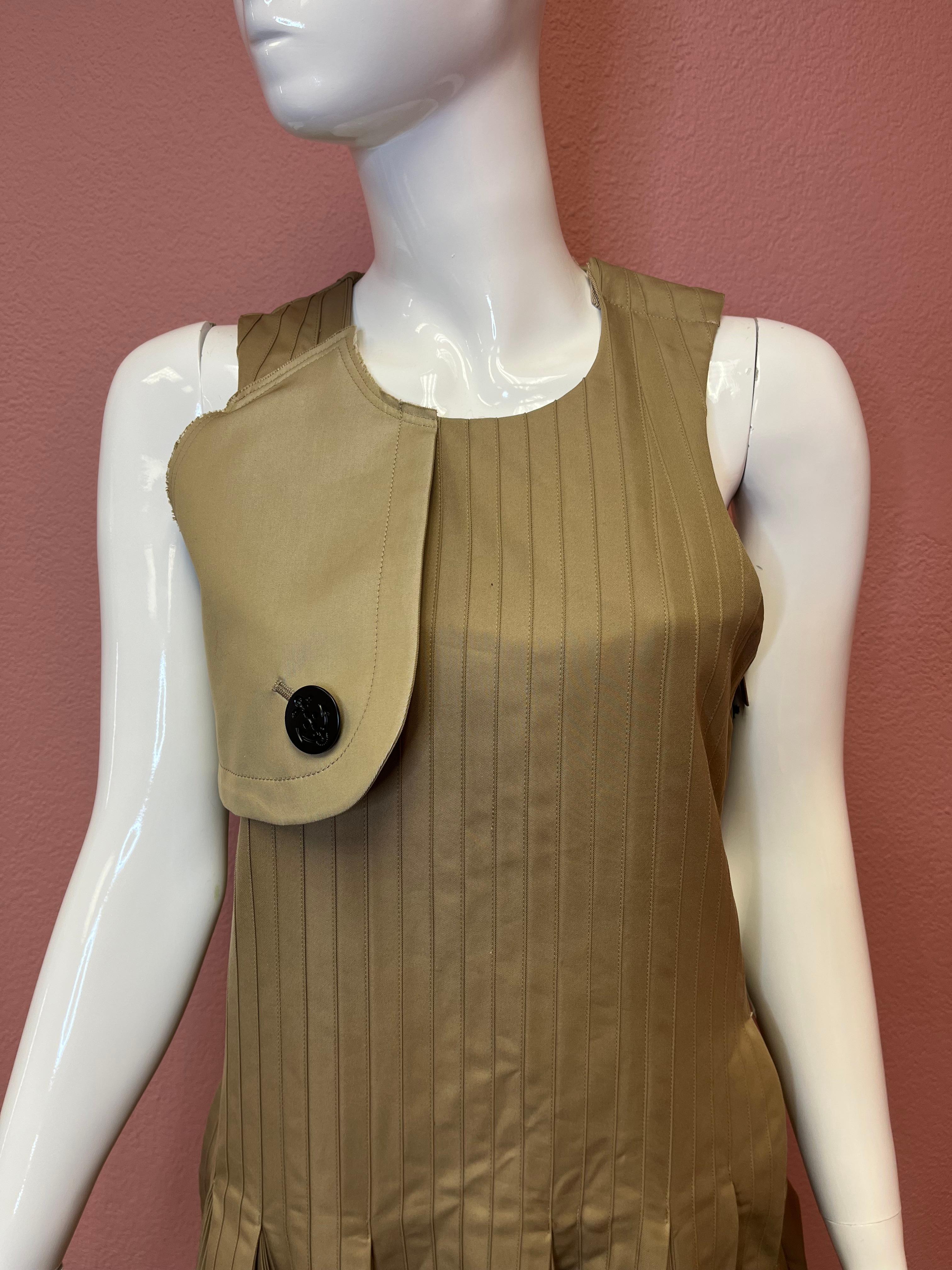 Brand New Sacai dress. Camel / Nude in color, sleeveless with a drop waist and flaring at the bottom. This is a super flattering style and cut. Perfect for any day outings, where you want to look conservative yet very chic. 

Tags still attached -