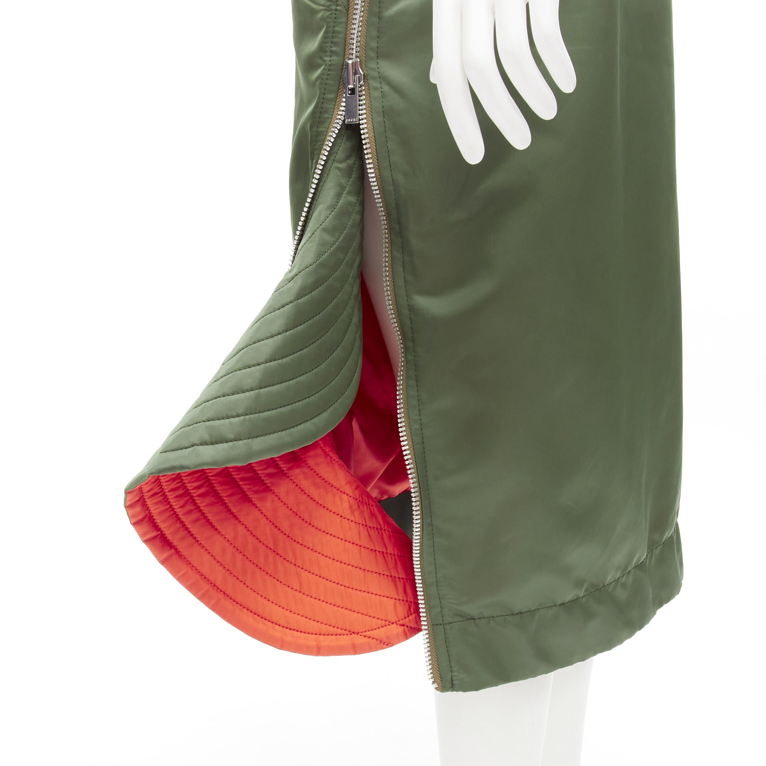 SACAI Chitose Abe green nylon deconstructed MA1 bomber flared skirt S
Brand: Sacai
Designer: Chitose Abe
Color: Green
Pattern: Solid
Closure: Stretchy
Extra Detail: Wide ribbed waist band with button tab details. Side zip closure. Ribbed flared