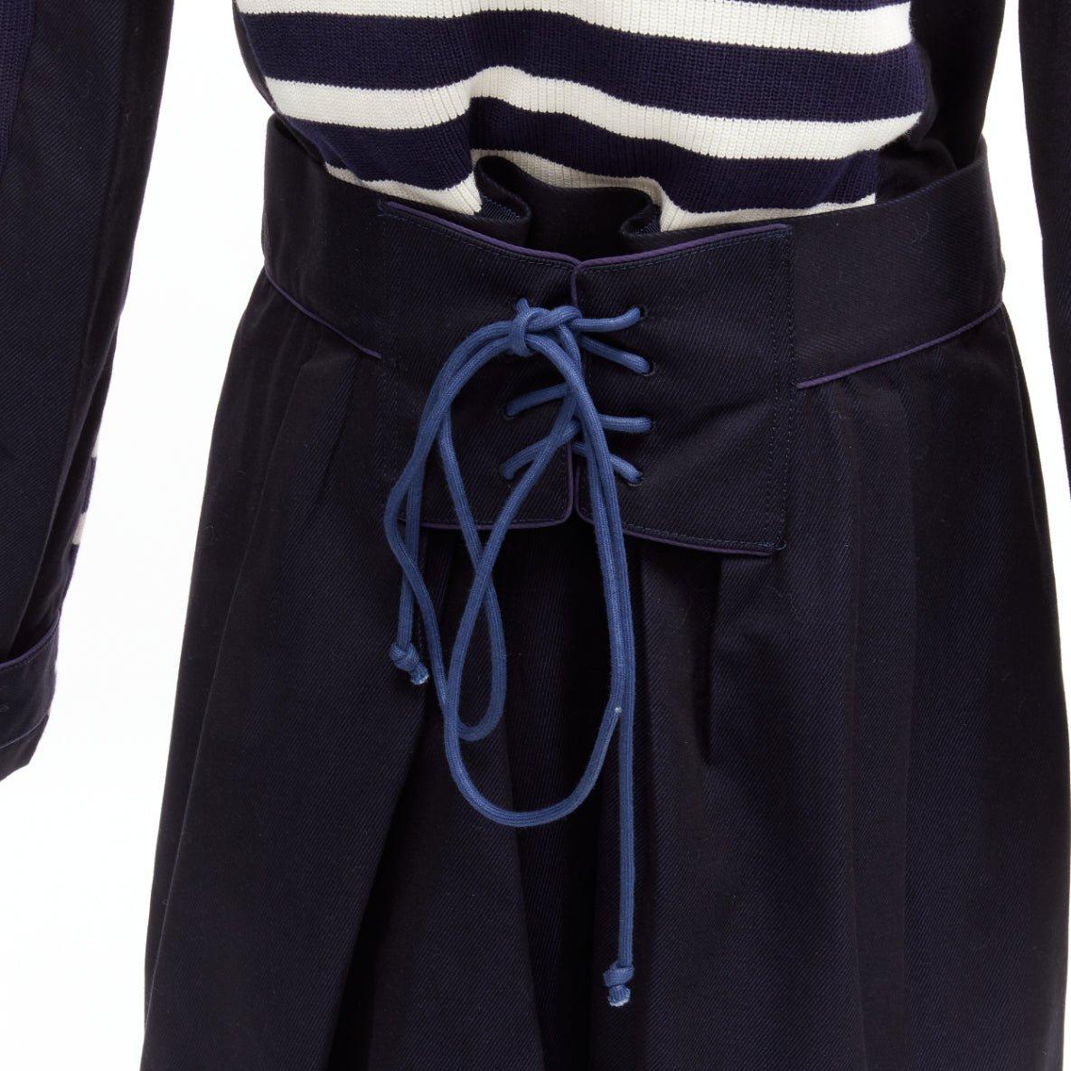 SACAI deconstructed nautical stripe detached corset belt flare coat JP3 L
Reference: CNPG/A00026
Brand: Sacai
Designer: Chitose Abe
Material: Cotton, Silk
Color: Navy, White
Pattern: Striped
Closure: Button
Lining: Blue Mesh
Extra Details: