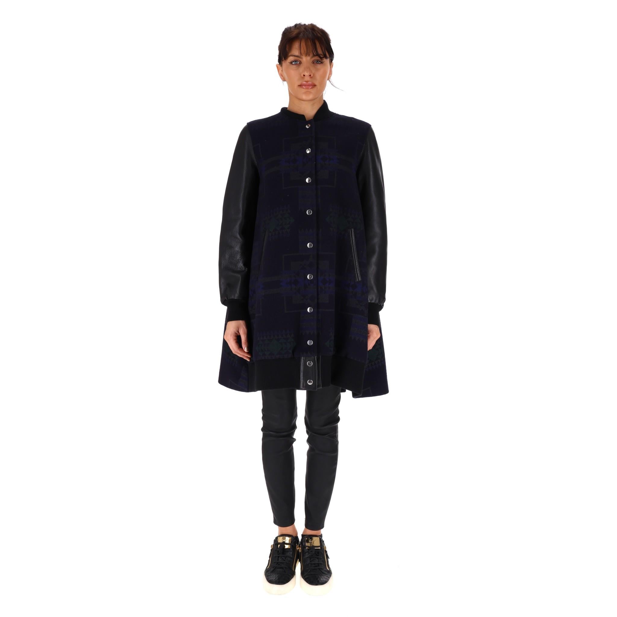 Sacai Luck 7 Wool & Leather Coat

Black coat with Aztec style patten to the wool body front, arms are black leather.

Swing style with silver press stud closure.

Rrp approx £1,700

Size - 3 - Large

Condition - Very Good

Composition - Wool, Leather