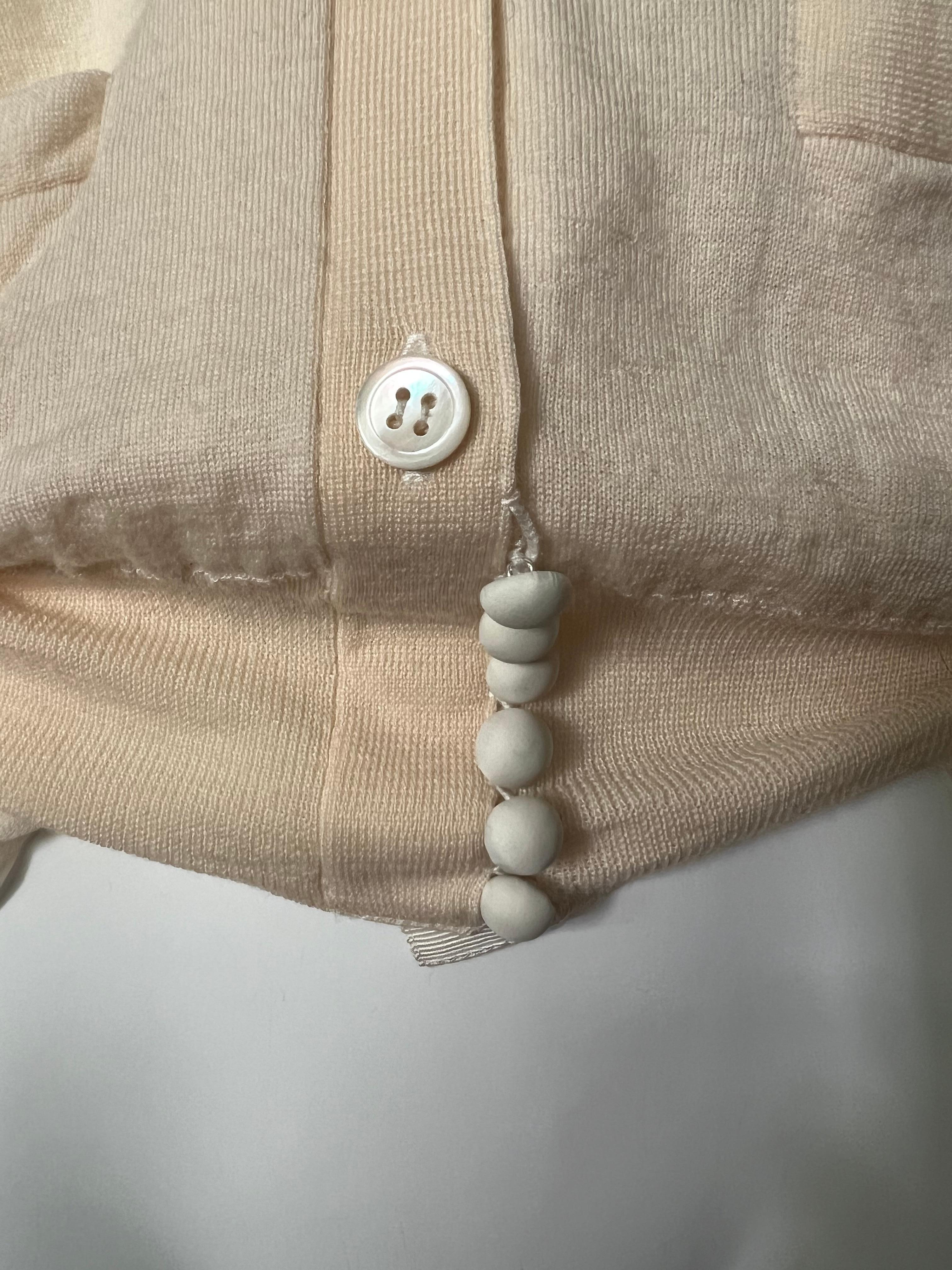 - V neckline
- Front button closure
- Front pockets 
- Ruffled design detail