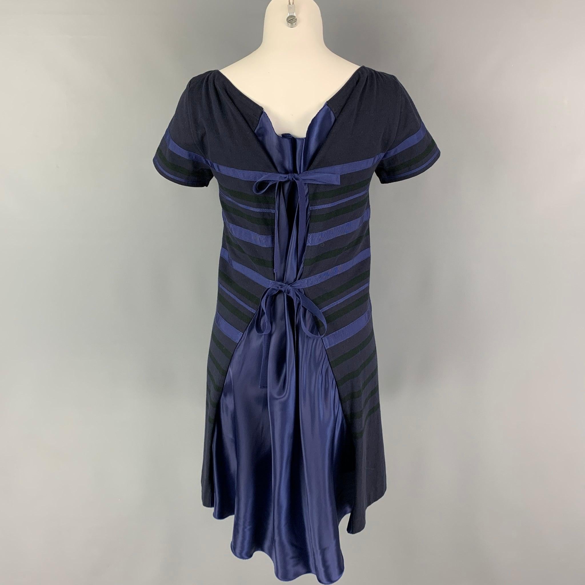 SACAI LUCK dress comes in a navy jersey mixed materials featuring a 
shift style, short sleeves, back satin panel, and back ribbon closure design.
Very Good
Pre-Owned Condition.
Fabric tag removed.  

Marked:   Size tag removed.  

Measurements: 

