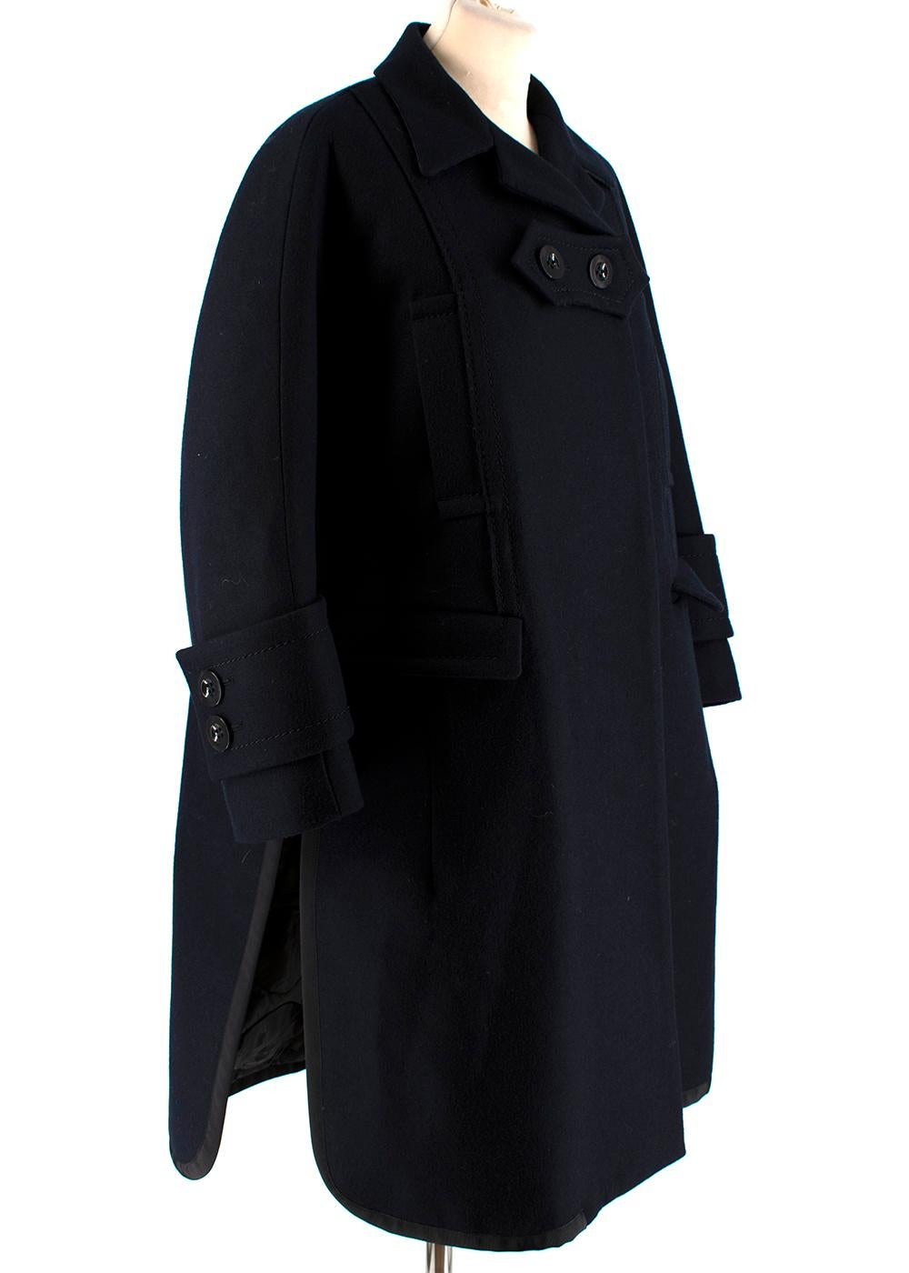 Sacai Navy Wool Double Vented Longline Coat

- Heavy wool longline coat 
- Concealed single breasted button fastening 
- Notched collar 
- Front flap pockets 
- Buttoned cuffs
- Double side vents with adjustable ribbon fastening 

Materials: 
Main -