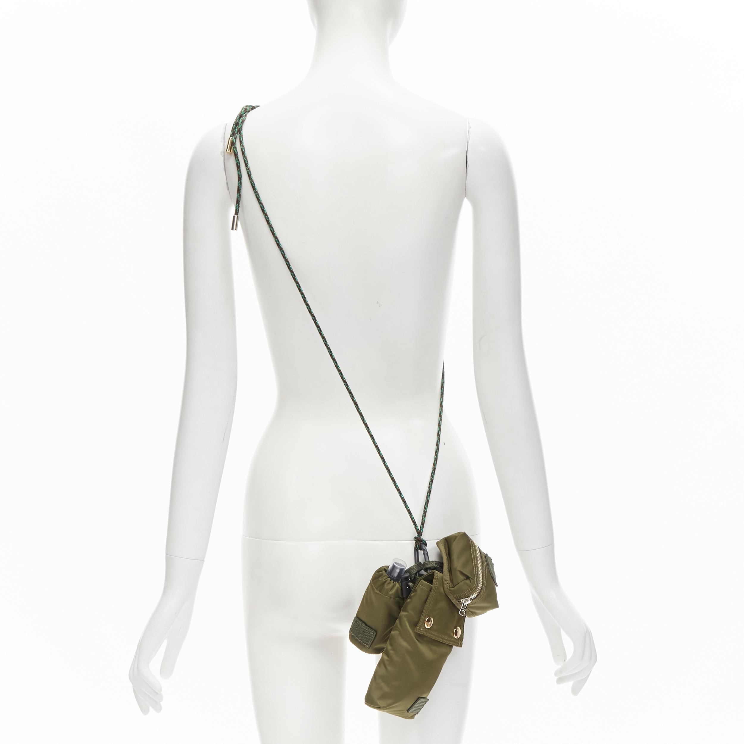 SACAI PORTER green nylon 3-in-1 pouch spray bottle lanyard crossbody bag 
Reference: ANWU/A00040 
Brand: Sacai 
Collection: PORTER collection 
Material: Nylon 
Color: Green 
Pattern: Solid 
Extra Detail: Attached with rein lock- detachable. 
Comes